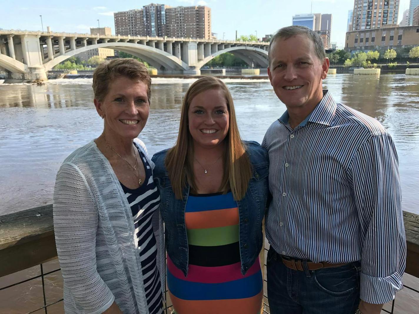 The bride and her parents posed for a photo near the Nicollet Island Pavillion.