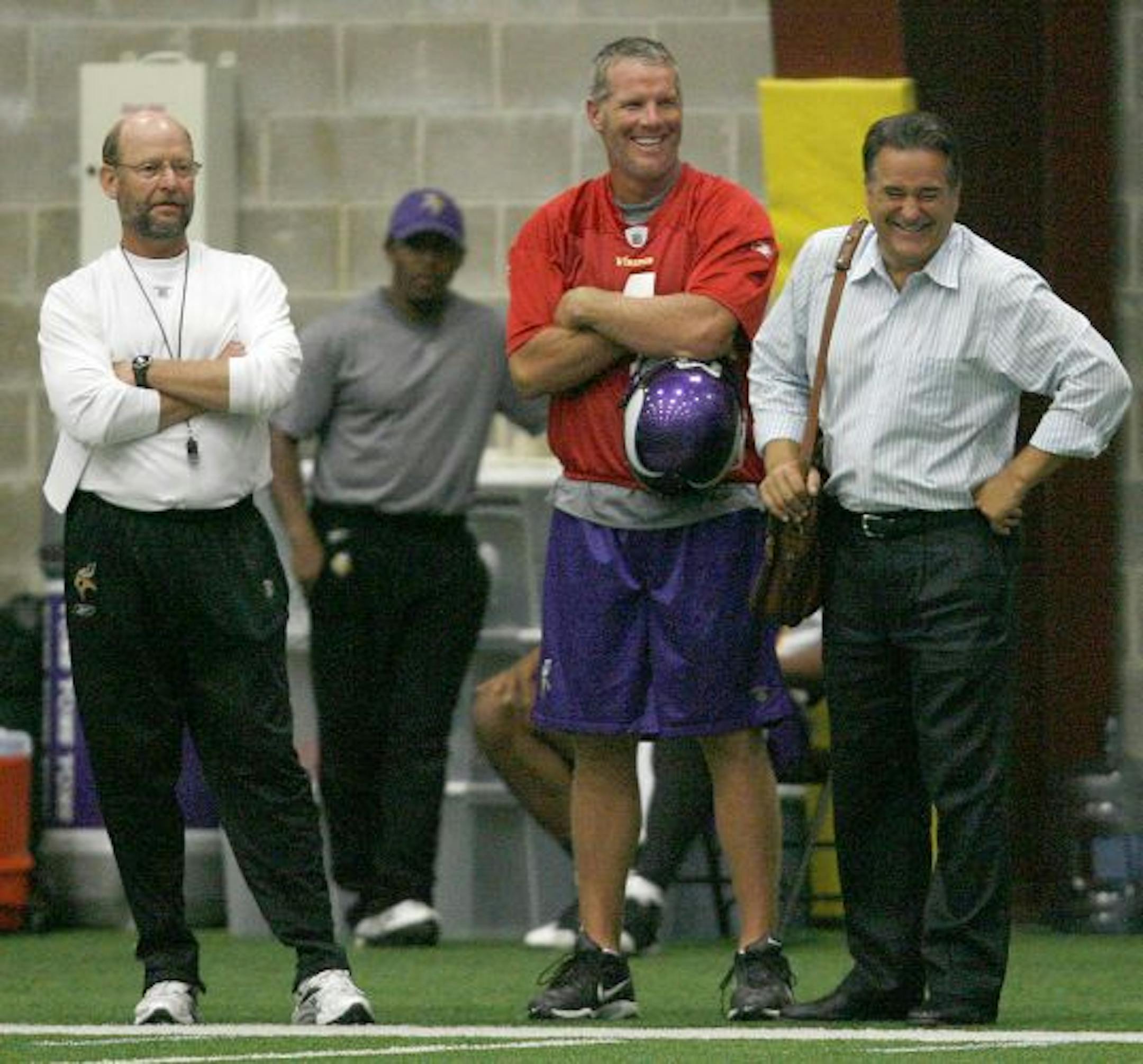 Brett Favre, flanked by Vikings coach Brad Childress, left, and former NFL coach Steve Mariucci, took a break during his second day of practice at Winter Park. His new teammates were impressed with how quickly Favre jumped in and took charge of the offense.