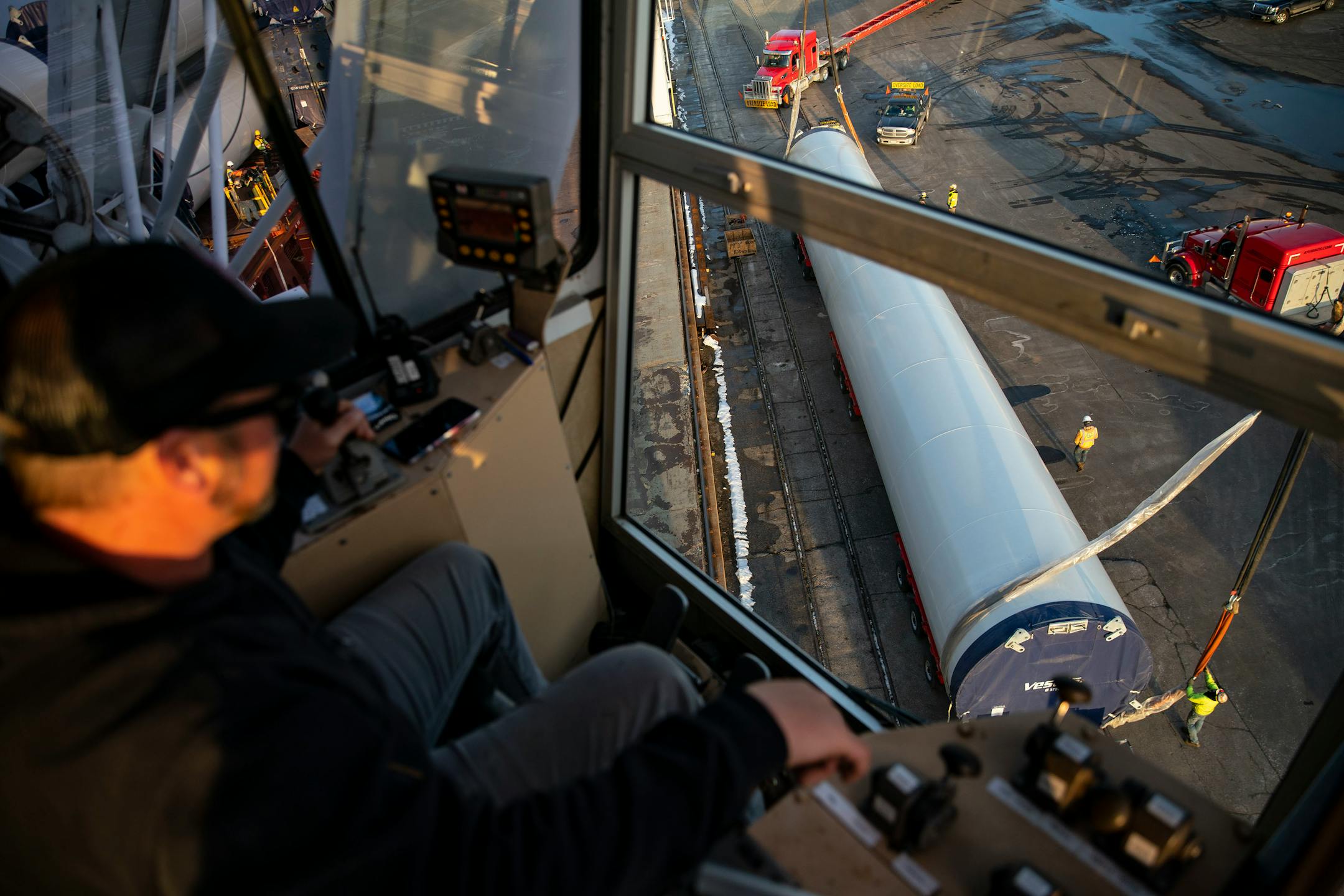 Keegan Beloy, a crane operator, worked in tandem with another crane to move a section of a wind turbine tower off the BBC Xingang and onto a flatbed truck.