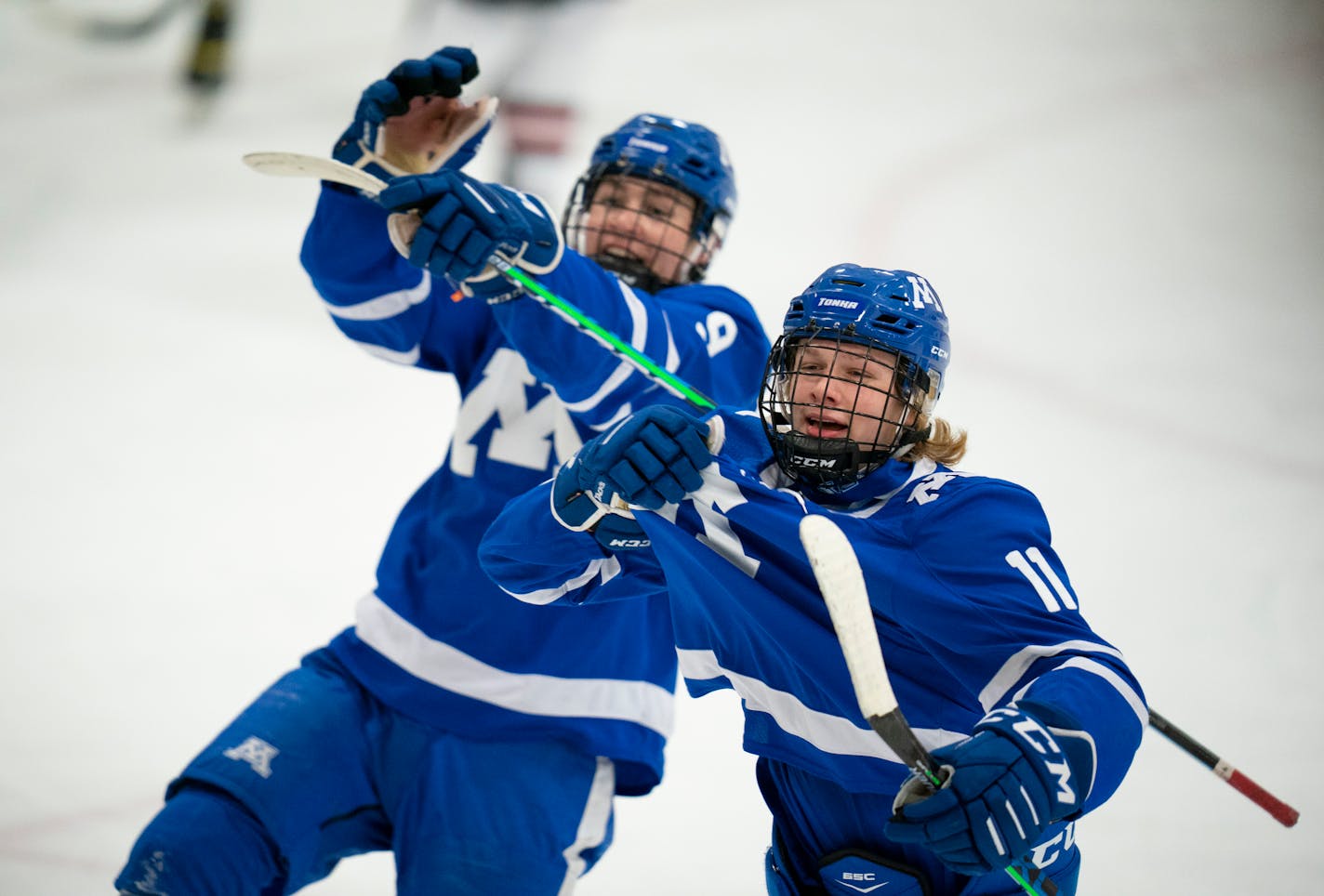 Minnetonka's Beckett Hendrickson (11) headed for the Minnetonka fans to celebrate his second period goal that put the Skippers up 3-1. With him was Graham Harris (9). ] JEFF WHEELER • jeff.wheeler@startribune.com