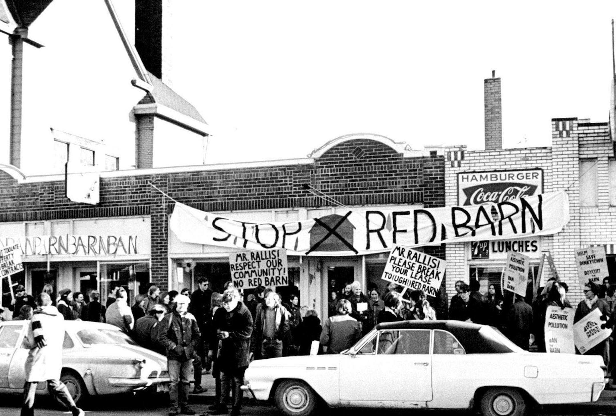 April 1, 1970 Group protesting demolition of Dinkytown stores picket the site early today The defenders of Dinkytown, a sleepy group of community residents and college and high school students, today rolled out of their sleeping bags, unfurled their banners and occupied three vacant stores on the site of a proposed franchise restaurant. The target of their protest is the Red Barn, Inc., a short-order franchise food operation that is to start demolition on five SE. 4th St. shops soon so that it c