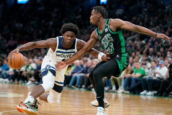 Wolves guard Anthony Edwards tried to get past Celtics guard Aaron Nesmith on Sunday in Boston.