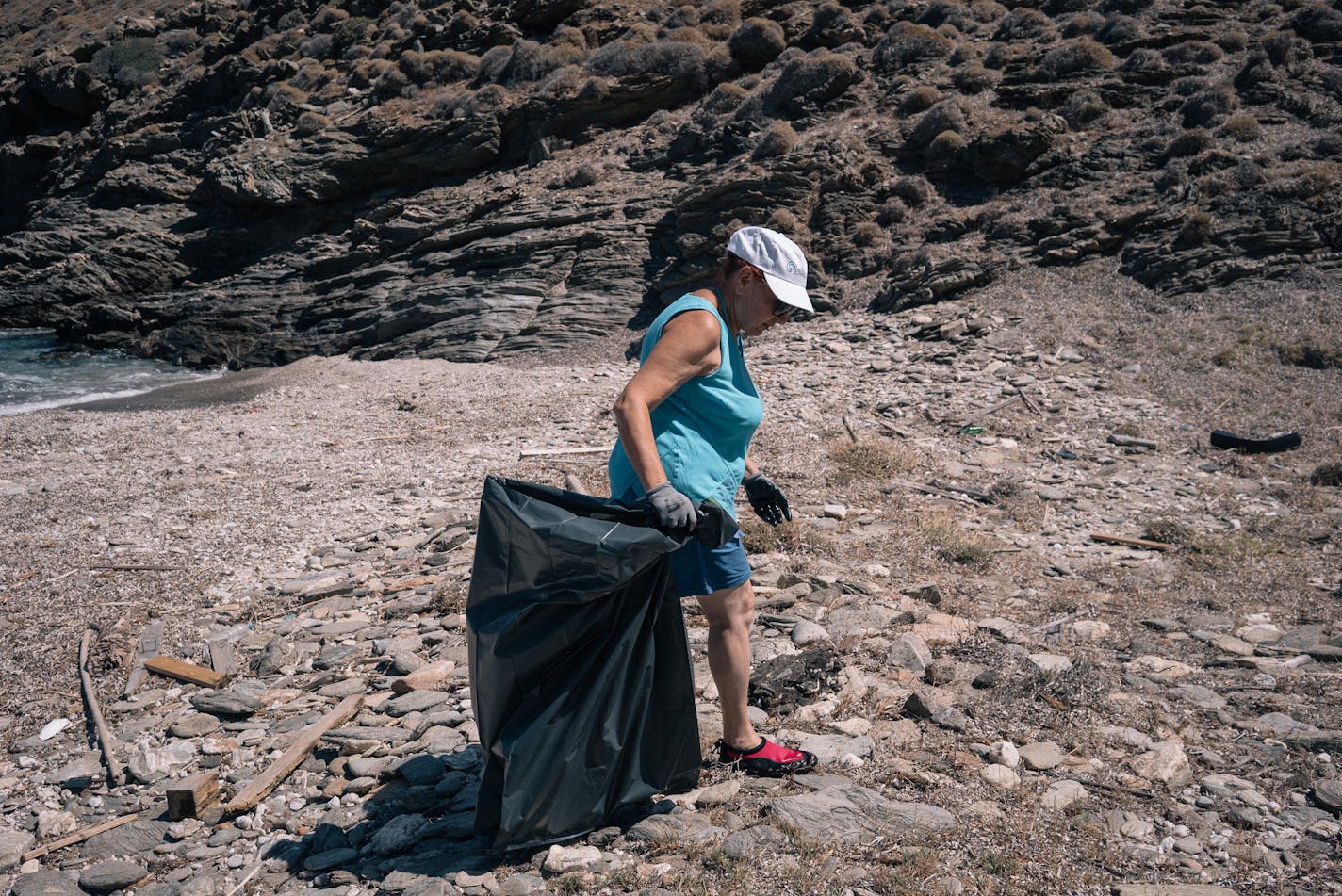 Irini Vlastari, 66, came on the cleanup venture with her son and two grandchildren. "You feel you're doing something, even if it's a little bit," she said. MUST CREDIT: Photo by Alice Martins for The Washington Post.