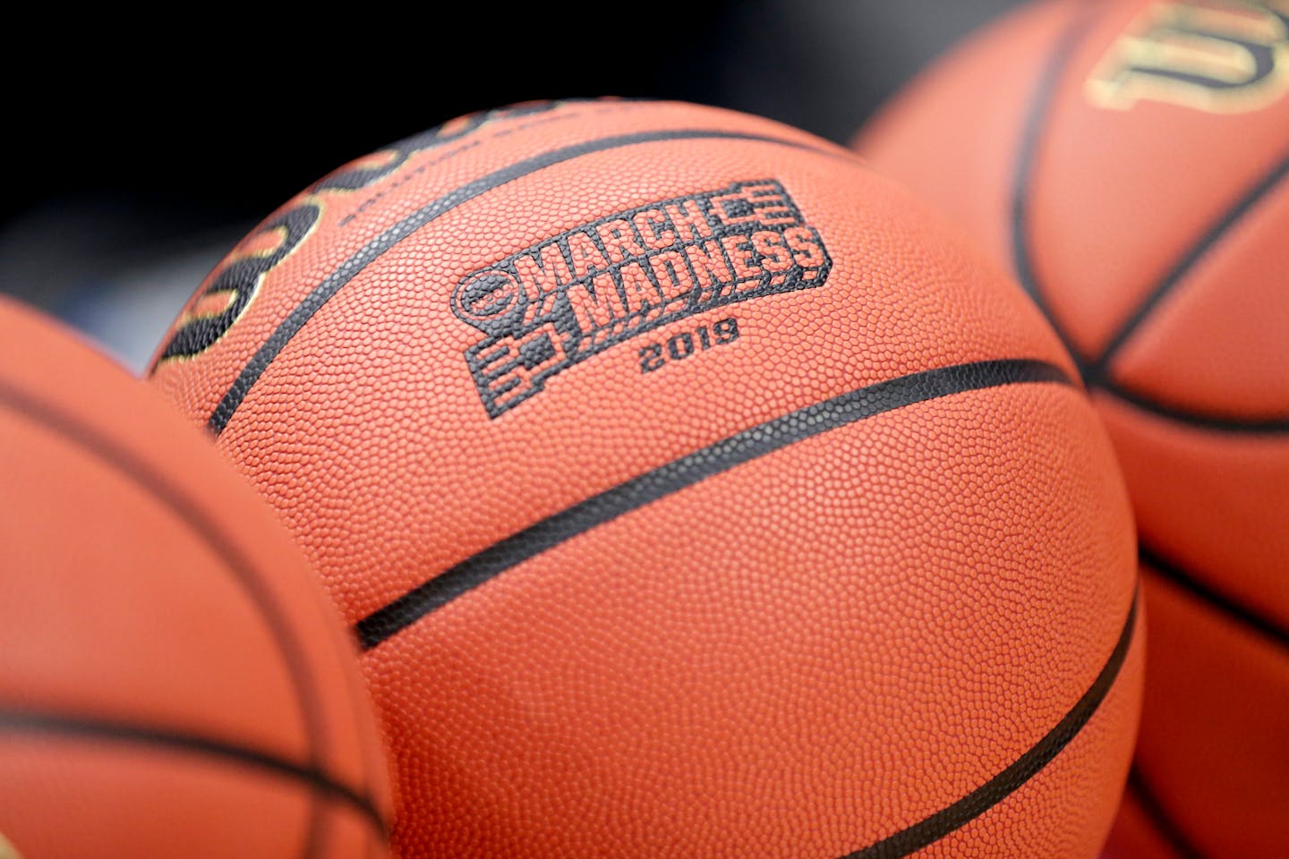 A basketball with March Madness 2019 sits in a rack before Michigan practice at the NCAA college basketball tournament.