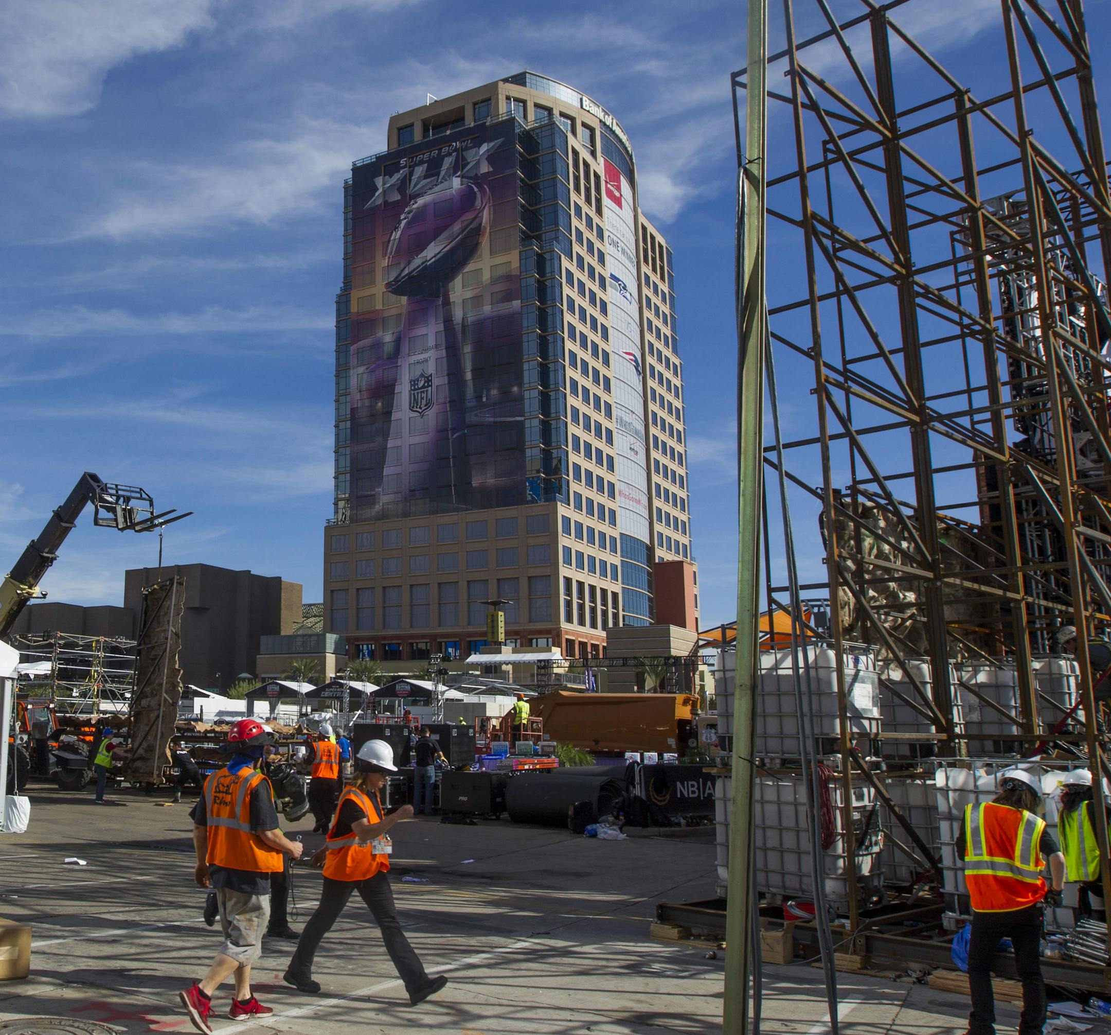 Construction and break down crews work on cleaning the day after the NFL Super Bowl XLIX football game between the New England Patriots and the Seattle Seahawks, Monday, Feb. 2, 2015, in Phoenix, Ariz. (AP Photo/The Arizona Republic, Patrick Breen) MARICOPA COUNTY OUT; MAGS OUT; NO SALES