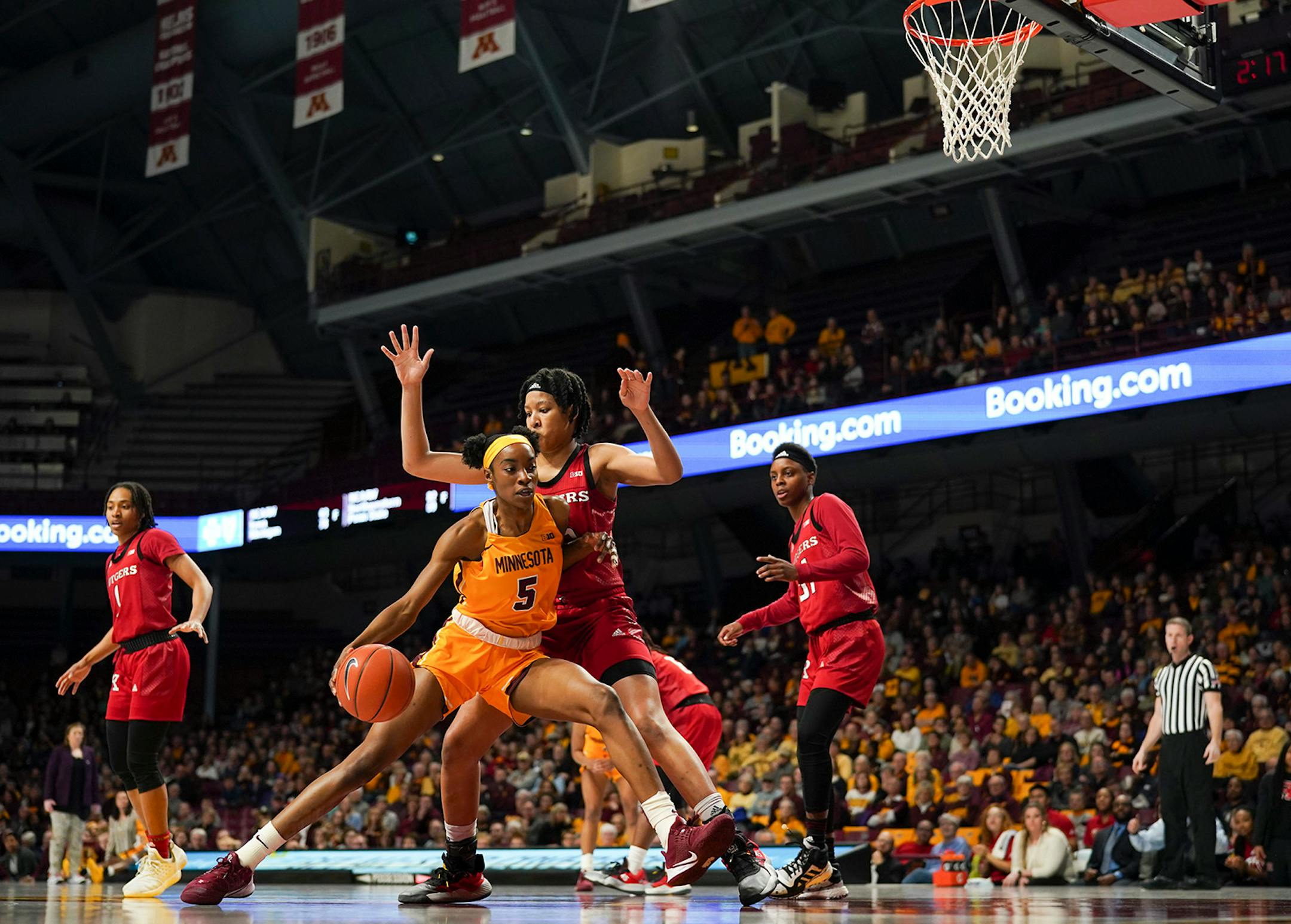 Minnesota Gophers forward Taiye Bello (5) drove into Rutgers Scarlet Knights center Maori Davenport (15) in the first quarter.