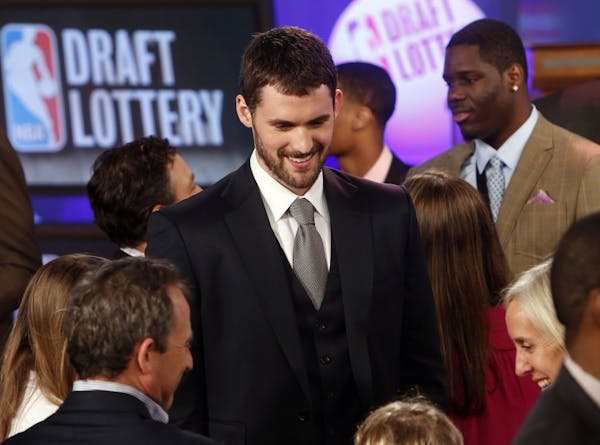 Minnesota Timberwolves' Kevin Love, center, mingles onstage before the NBA basketball draft lottery