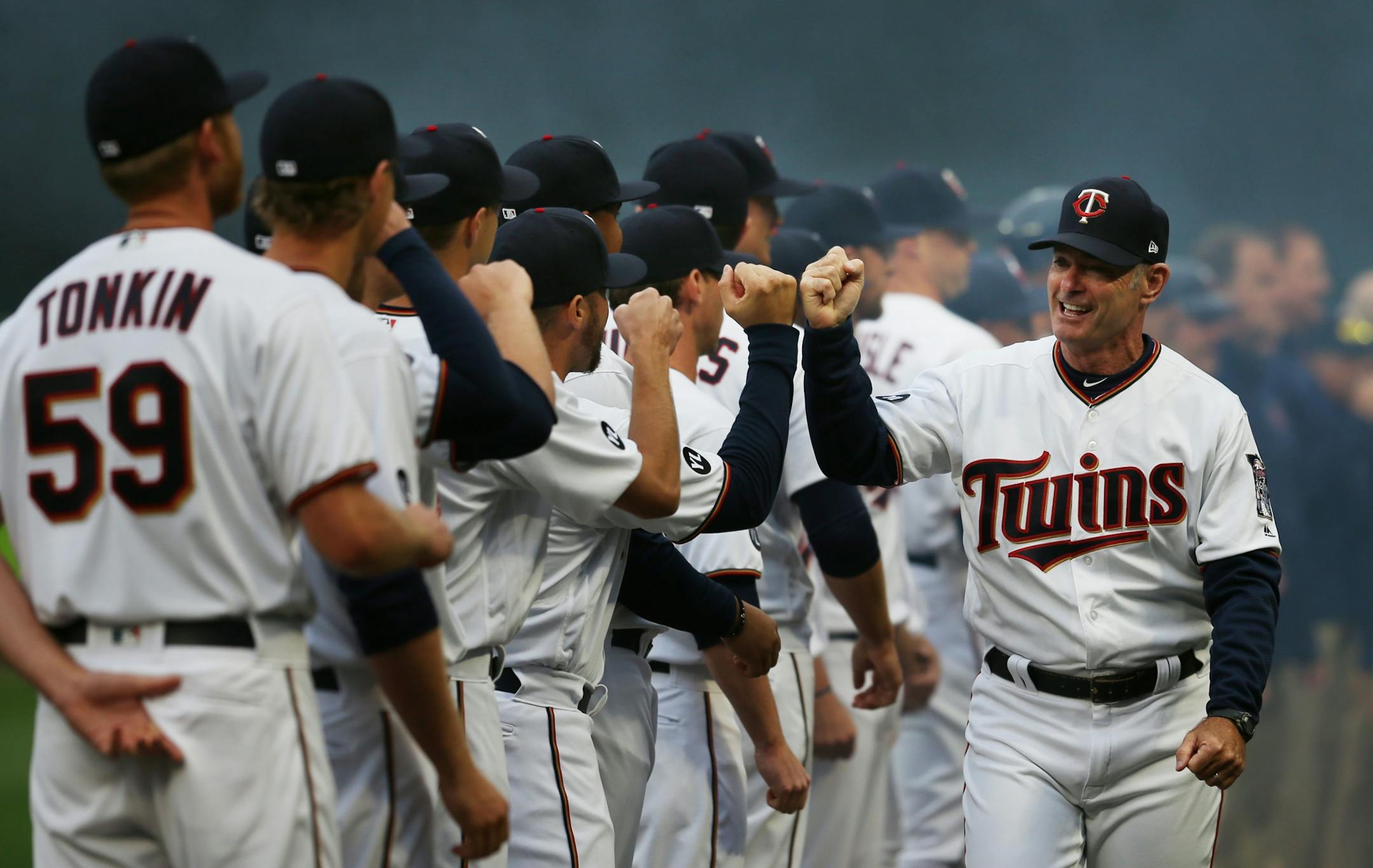 Twins manger Paul Molitor fist bumped members of his team at Target Field on Opening Day.