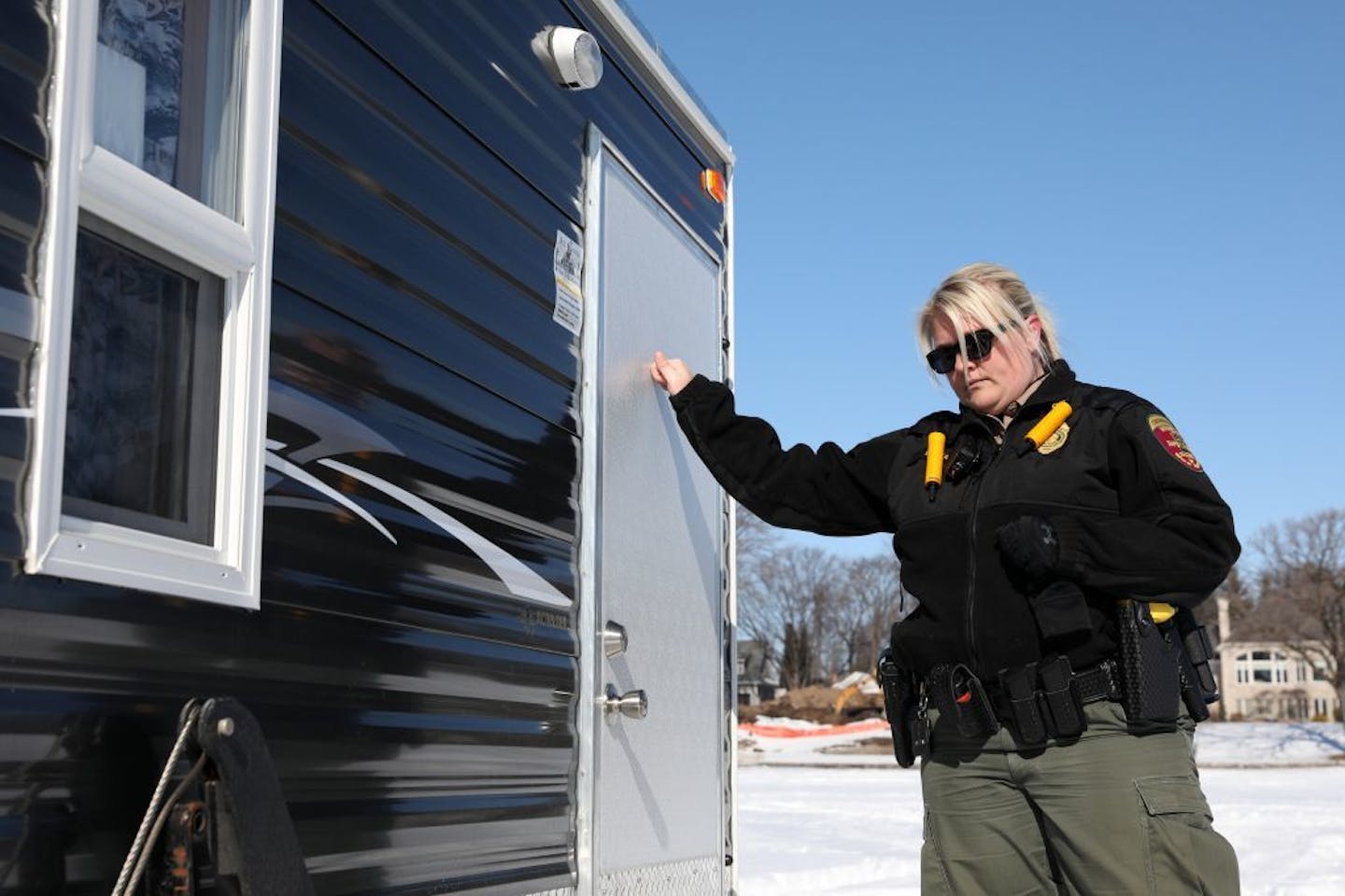 Minnesota Department of Natural Resources conservation officer Leah Weyandt knocked on the door of an ice fishing shelter Thursday at Lake Minnetonka.