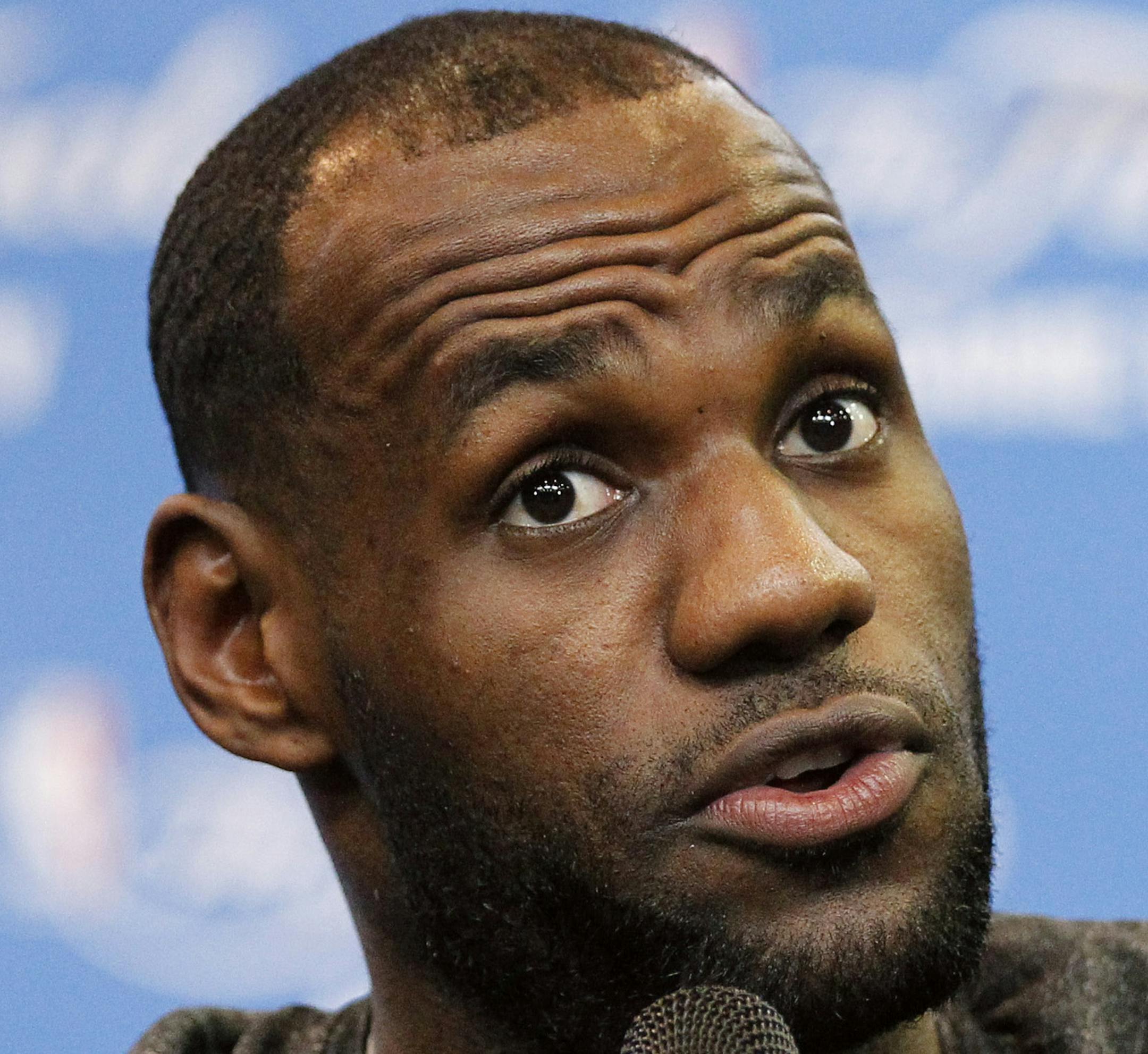 FILE - In this June 14, 2014 file photo, Miami Heat forward LeBron James responds to a question during a media availability for the NBA basketball finals in San Antonio. A person familiar with the deals says the Cavaliers have agreed to trade guard Jarrett Jack, swingman Sergey Karasev and center Tyler Zeller, moves that can help their pursuit of LeBron James by clearing salary cap space. The Cavs have agreements with the Brooklyn Nets and Boston Celtics, according to the person who spoke Wednes