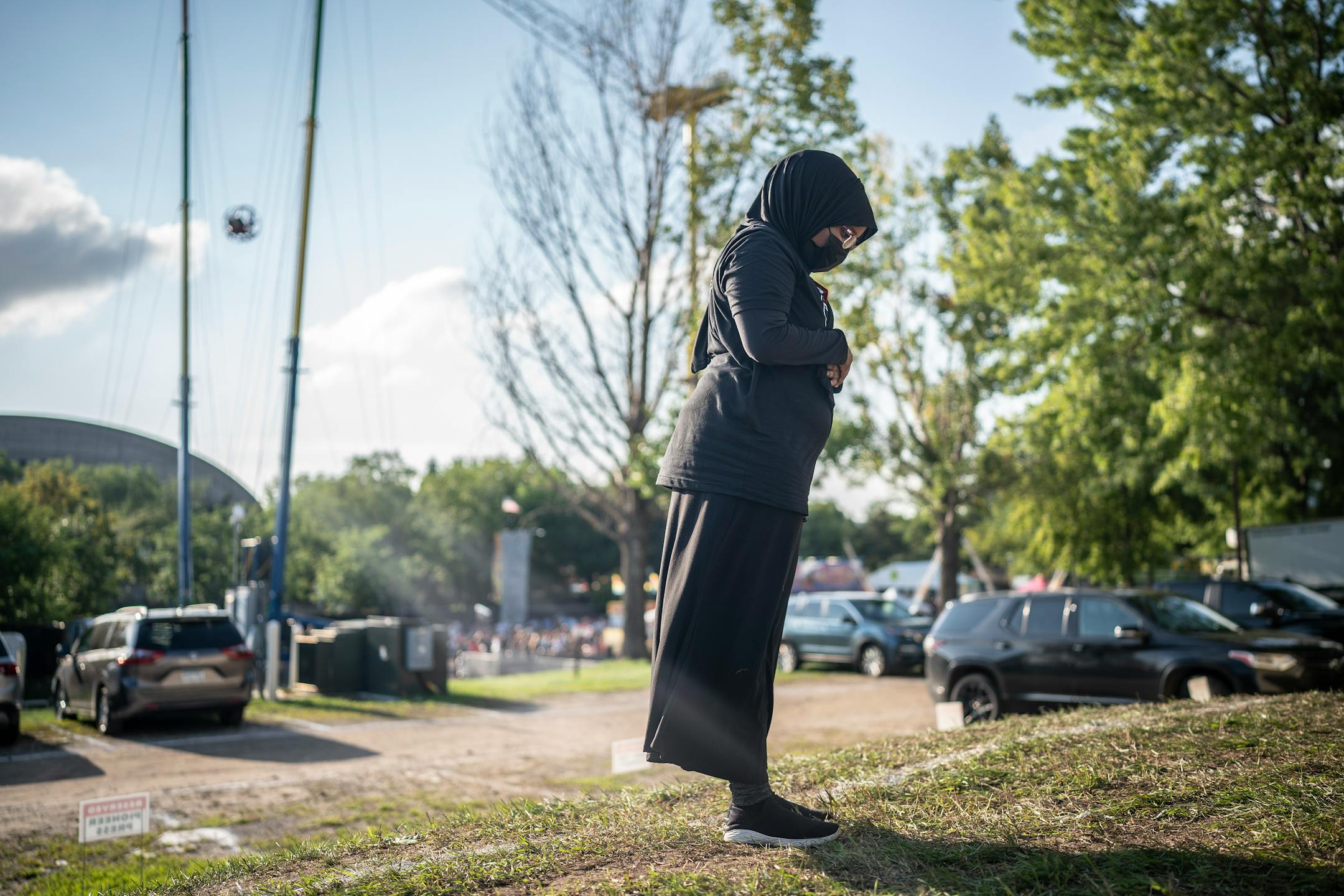 Sixteen-year-old Fahma Ahmed, a Muslim, prayed in the evening outside the Dairy Building at the Minnesota State Fairgrounds. Ahmed works as a cashier at the Dairy Building.