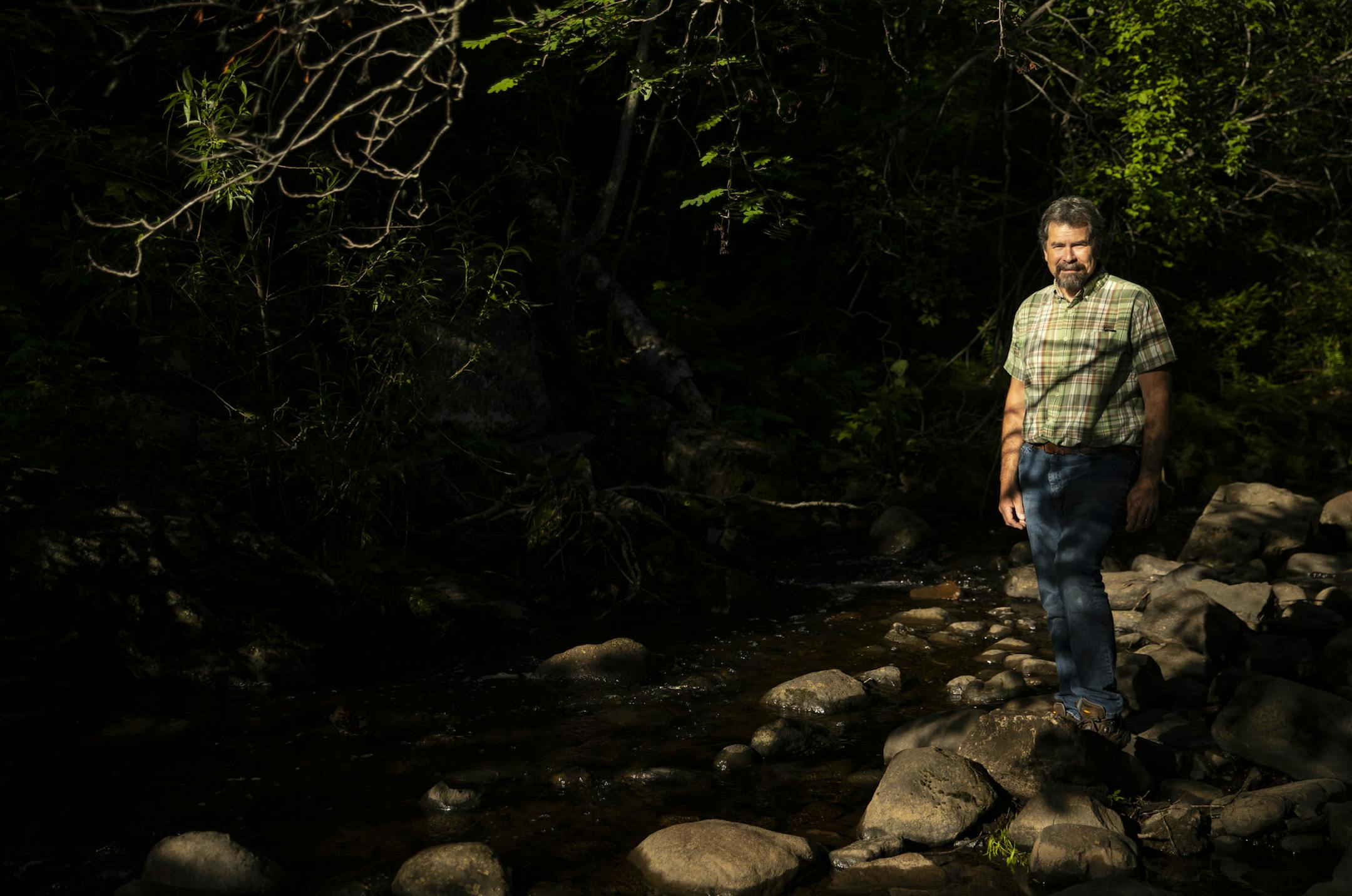 Todd Carlson posed for a portrait at Chester Creek in Duluth on Monday. ] ALEX KORMANN • alex.kormann@startribune.com Todd Carson is retiring after 20 years as the watcher of Duluth's maze of pipes and culverts, protector of lakes and streams. He posed for portraits at Chester Creek in Duluth on Monday July 27, 2020.