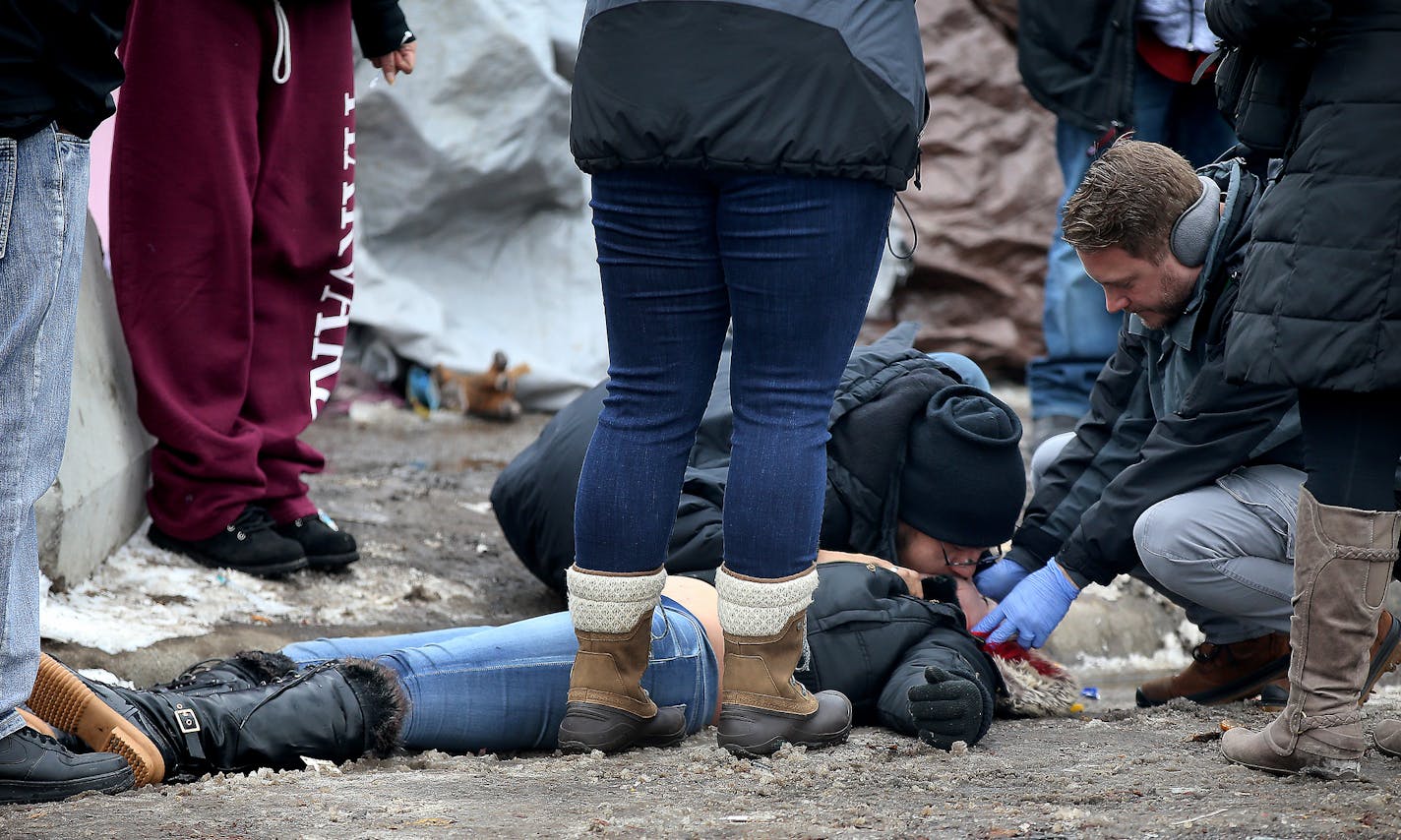 Inhabitants of a large homeless encampment in south Minneapolis prepare for an important deadline next week to relocate to a temporary shelter nearby. Here, encampment residents and medical personnel attend to a resident who overdosed Wednesday, Dec. 5, 2018, at the Hiawatha homeless encampment in Minneapolis, MN. The person was revived with narcan and transported to a hospital by ambulance.] DAVID JOLES &#xef; david.joles@startribune.com Facing a Dec. 15 deadline to move to a new site, the Hiaw