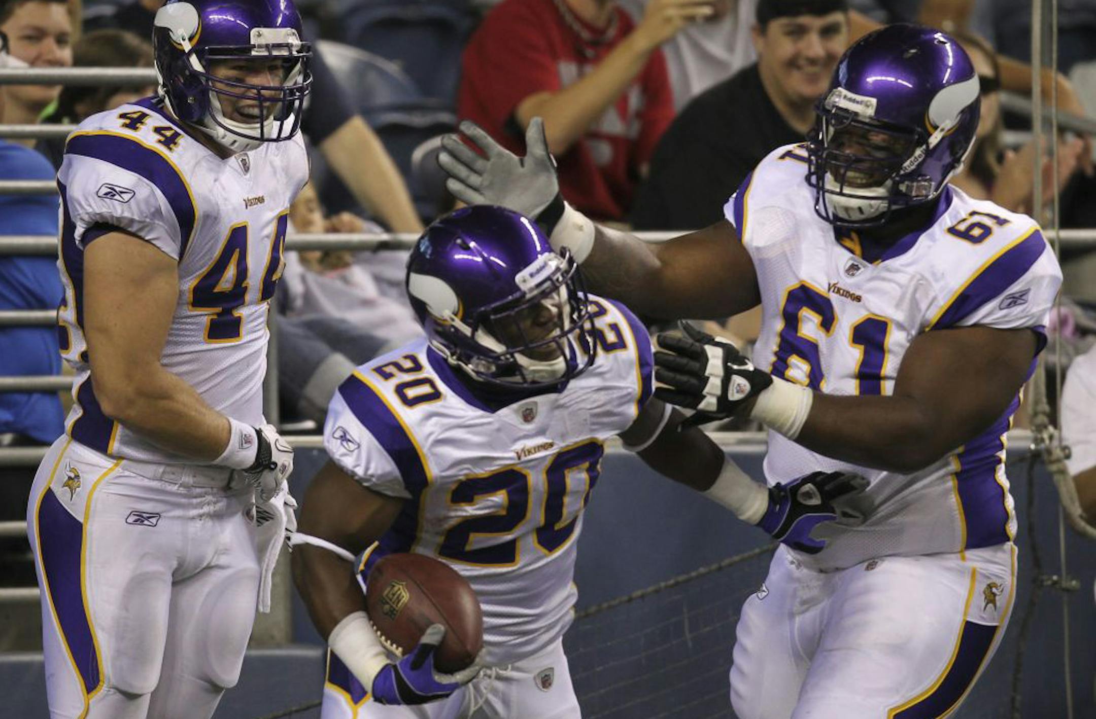 Vikings running back Tristan Davis (20) was congratulated after his 35-yard touchdown run in the fourth quarter by Ryan D'Imperio (44) and Cedric McKinley in Minnesota's 20-7 preseason victory over Seattle on Saturday.