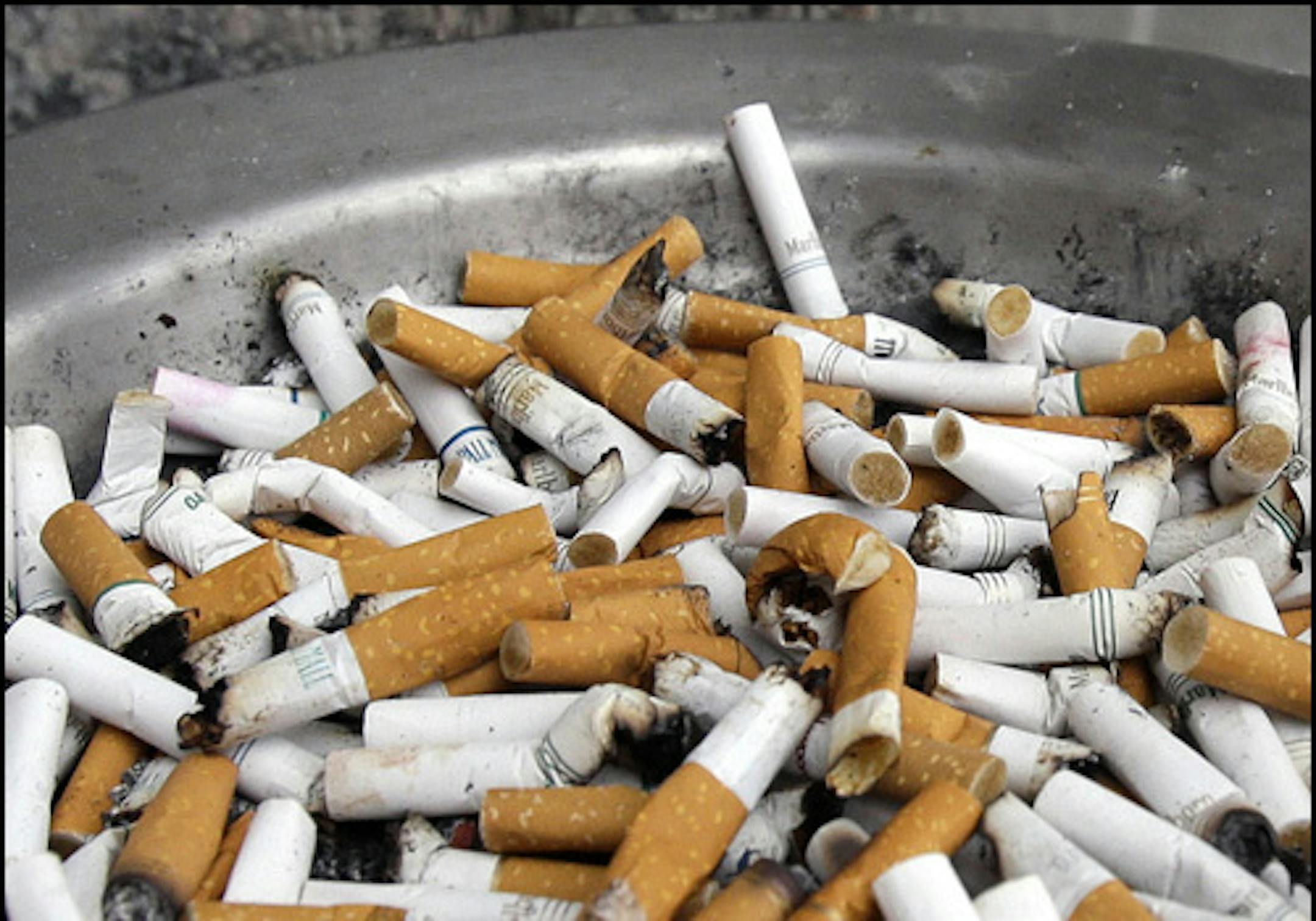 FILE - In this Feb. 7, 2013 file photo, cigarette butts fill the ash tray at the State Capitol complex in St. Paul, Minn. The 2013 Legislature passed a new cigarette tax of $1.60 a pack which is intended to help fund the state's $348 million share of the $975 million Minnesota Vikings NFL football stadium after tax revenue from an expansion of electronic gambling badly lagged behind projections. (AP Photo/Jim Mone,File) ORG XMIT: MIN2013052115113131 ORG XMIT: MIN1305211718280464