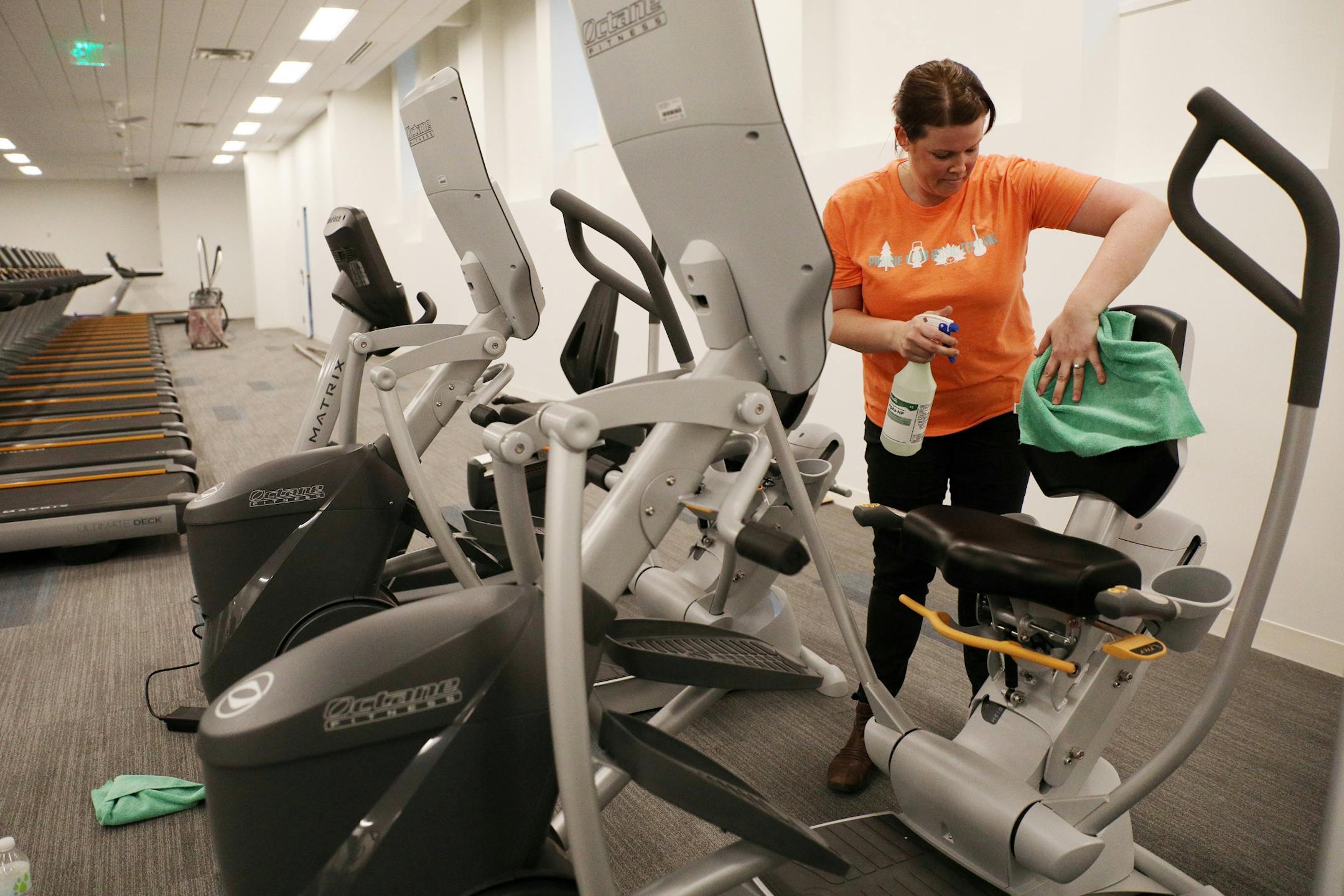 YMCA employee Melody Royse cleaned exercise equipment in preparation for the grand opening.