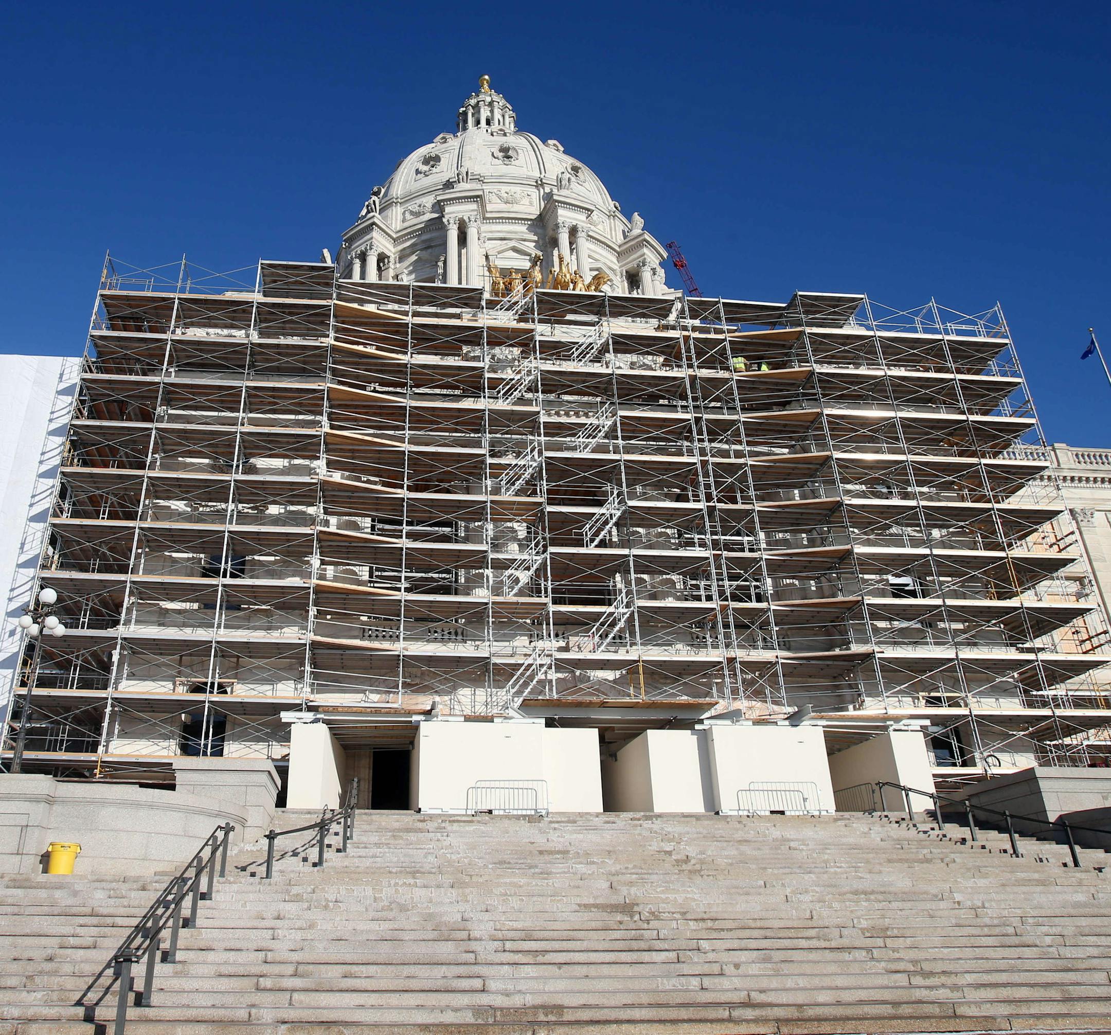ADVANCE FOR SUNDAY, NOV. 30 2014, AT 12:01 A.M. CST. AND THEREAFTER- In this photo taken Tuesday, Nov. 25, 2014, protective wrap covering, left, and scaffolding hid the graceful lines of the Minnesota state Capitol as the massive renovation continues in St. Paul, Minn. The working sections of the building have been so disrupted by the overhaul that lawmakers will find the going tough this upcoming session. (AP Photo/Jim Mone)