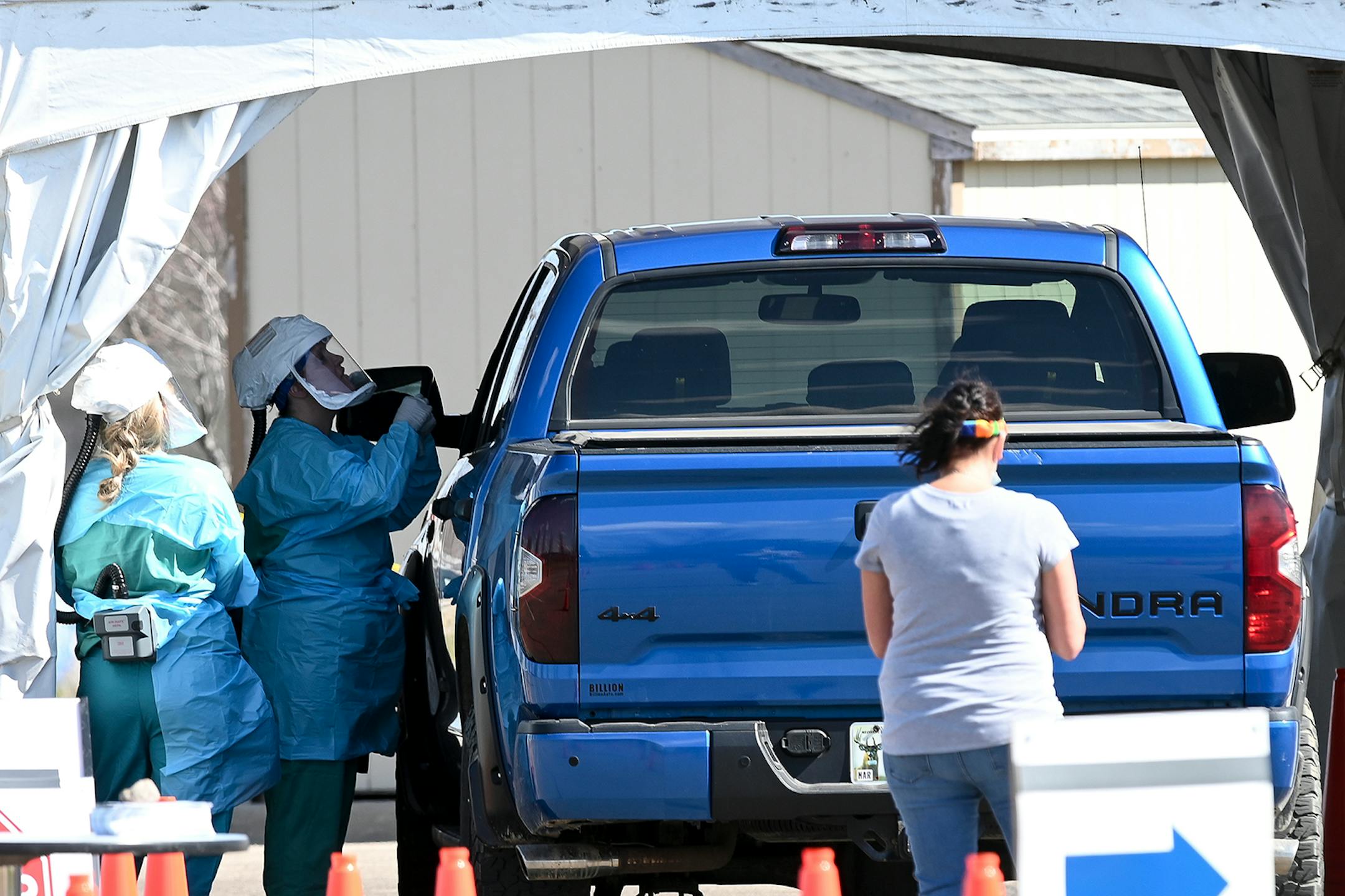 Medical workers administered drive-up COVID-19 tests Saturday outside the Sanford Worthington Clinic. At least 19 cases were confirmed at the JBS pork plant here, an hour east of the Smithfield Foods pork plant in Sioux Falls, which was shut down last week when nearly 300 workers were infected with the disease.