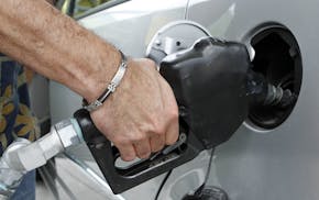 A customer fills up his tank at a local gas station in Miami, Friday, May 27, 2011. With gas prices still topping the $4-a-gallon mark in much of the