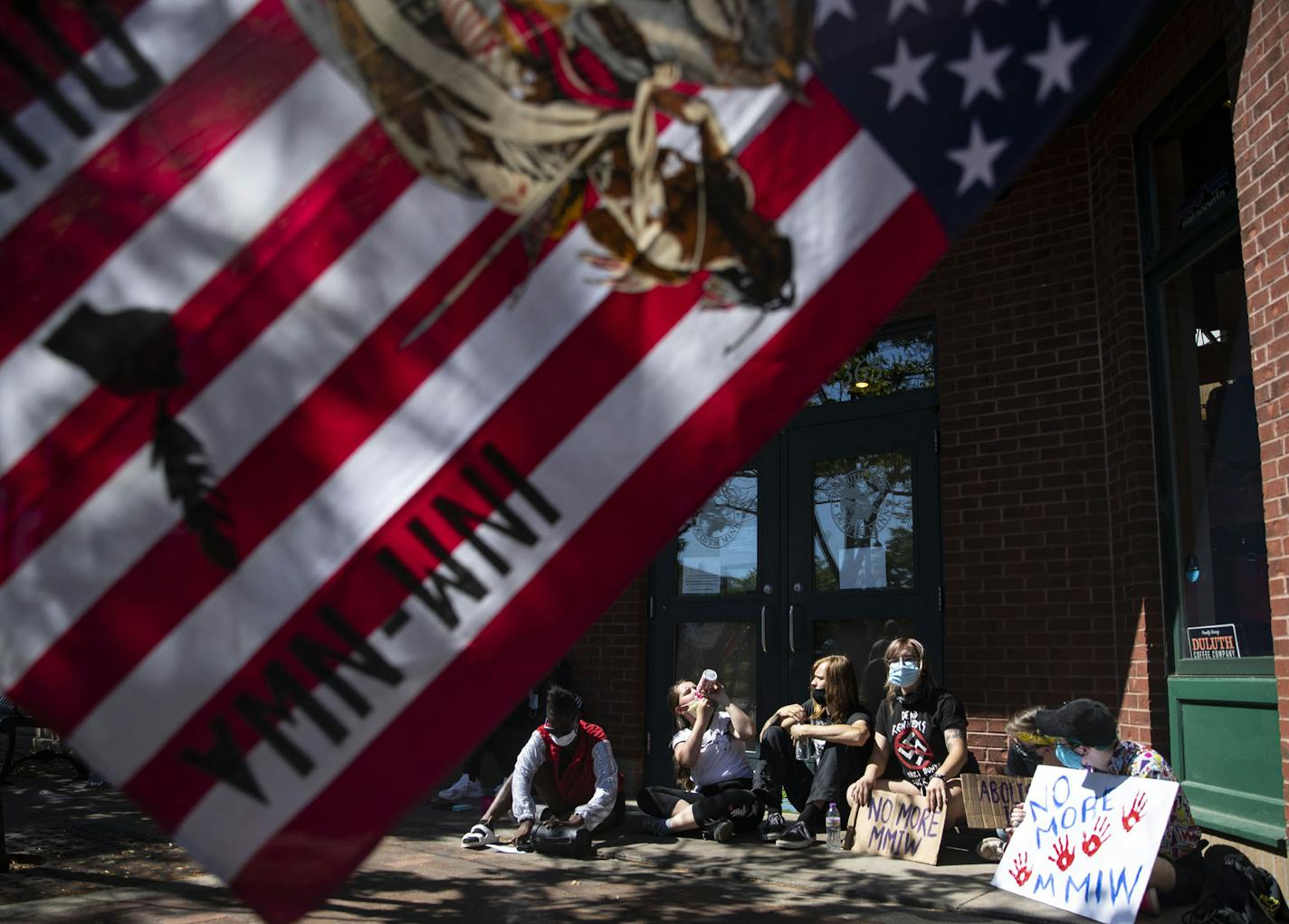 Protestors held a short sit-in outside of Duluth Pack where Ivanka Trump had left only twenty minutes earlier on Monday. ] ALEX KORMANN • alex.kormann@startribune.com Ivanka Trump, U.S. Secretary of the Interior David Bernhardt and U.S. Representative Pete Stauber toured Duluth Pack in Canal Park in Duluth on Monday July 27, 2020. The trio were there to witness Duluth Pack sign the Pledge to America's workers. A small group of protestors stood outside the store with signs and props.