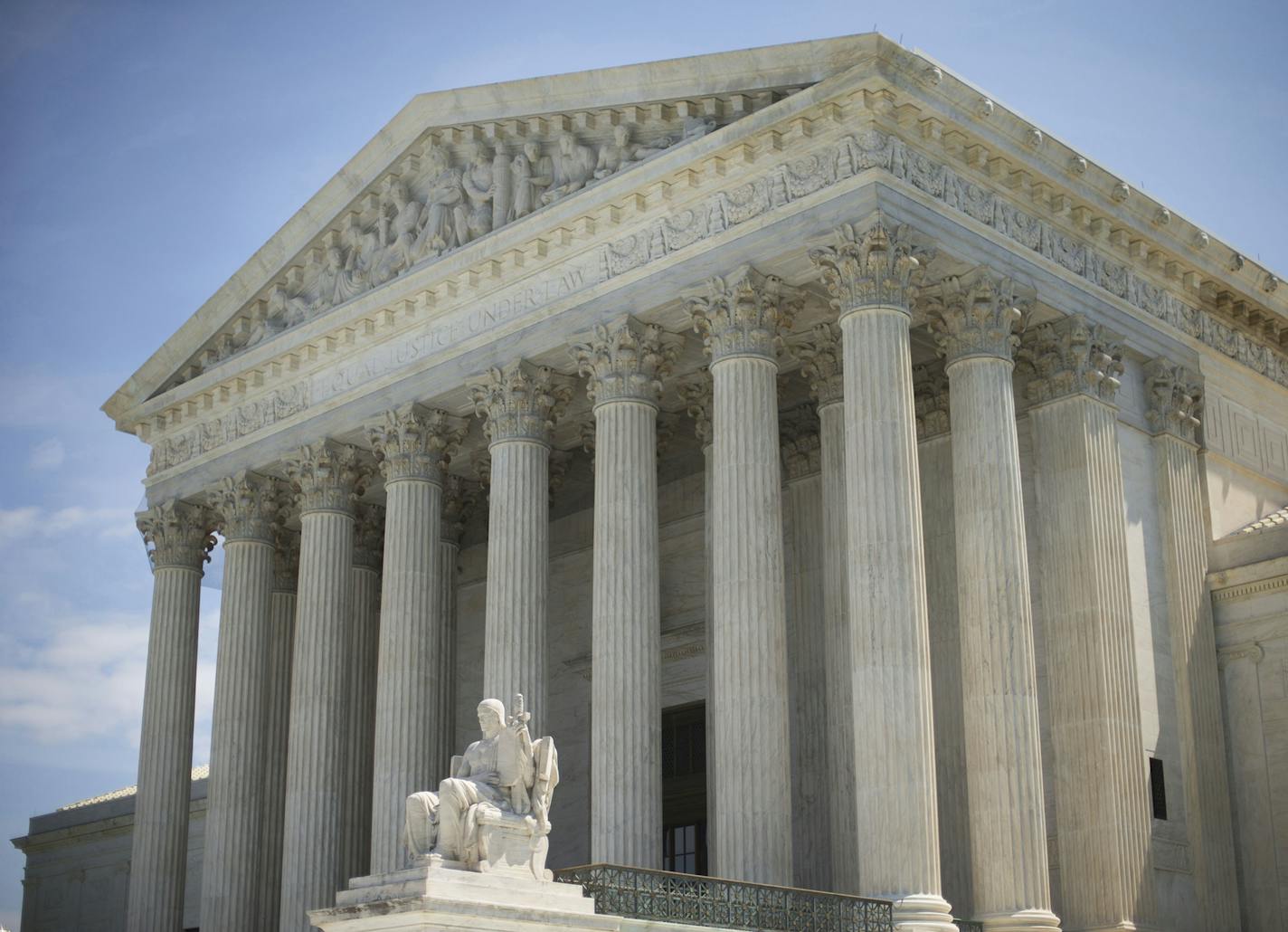 The Supreme Court building following the court's decision on the Hobby Lobby case in Washington, Monday, June 30, 2014. The Supreme Court says corporations can hold religious objections that allow them to opt out of the new health law requirement that they cover contraceptives for women.(AP Photo/Pablo Martinez Monsivais) ORG XMIT: MIN2014070112043417