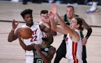 Boston Celtics guard Kemba Walker (8) attempts to maintain control of the ball in front of Miami Heat forward Jimmy Butler (22) and Kelly Olynyk