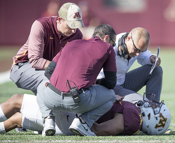 Minnesota's Head Coach P. J. Fleck checked on Minnesota's defensive back Antoine Winfield Jr. during the first quarter as the Gophers took on Maryland
