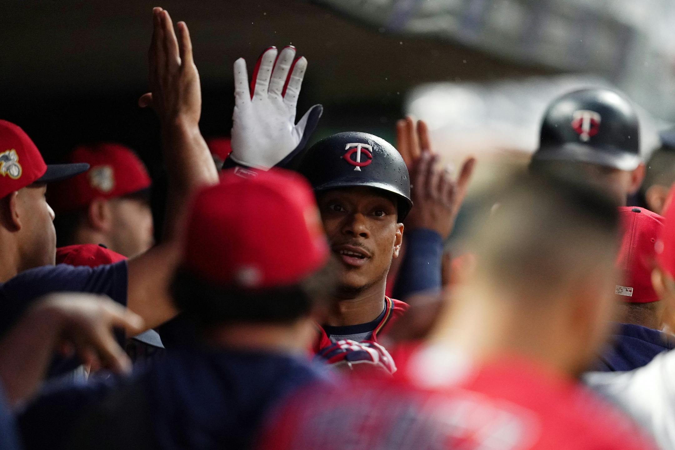 Minnesota Twins shortstop Jorge Polanco (11) celebrated with his teammates in the dugout after hitting a home run in the second inning.