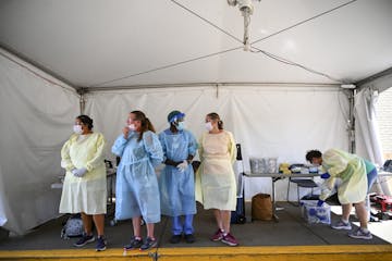 North Memorial health care workers waited for their next drive-up patient at a COVID-19 testing center behind the North Memorial Health Specialty Cent