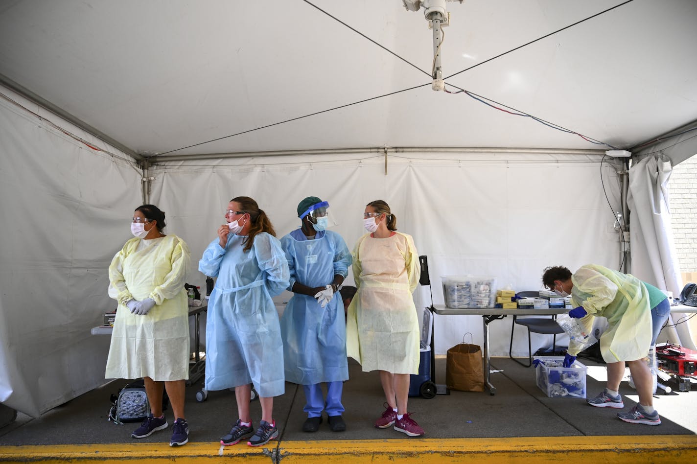 North Memorial health care workers waited for their next drive-up patient at a COVID-19 testing center behind the North Memorial Health Specialty Center in Robbinsdale on July 29. The hospital was cited by MNOSHA for failing to train workers to use a form of breathing protection called a powered air-purifying respirator.