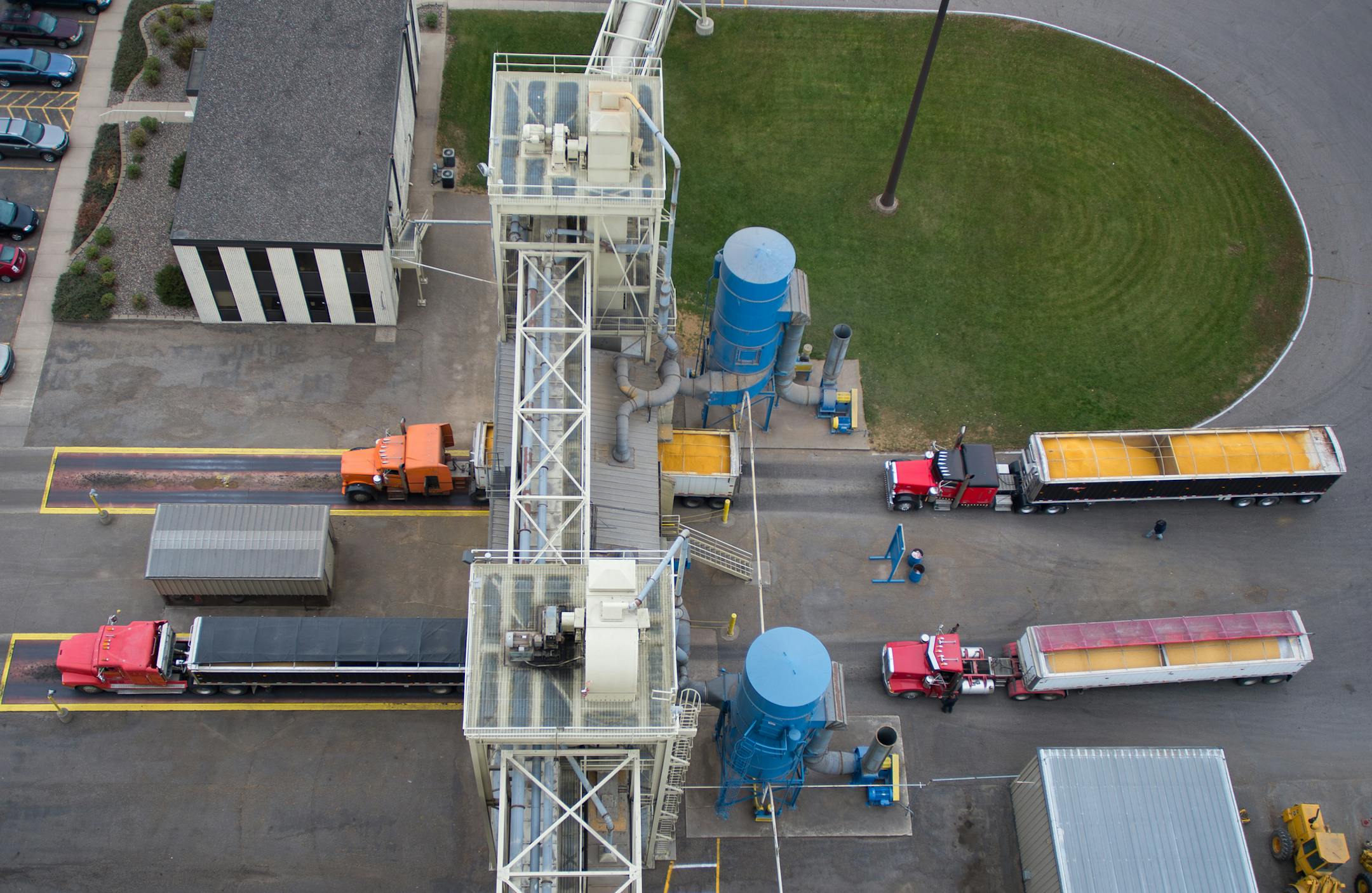 Grain trucks are moved through the CHS Grain Terminal on Friday as drivers unload their cargo. ] AARON LAVINSKY • aaron.lavinsky@startribune.com Photographing the process of unloading grain from trucks onto river barges at the CHS Grain Terminal in Savage on Friday, November 7, 2014.