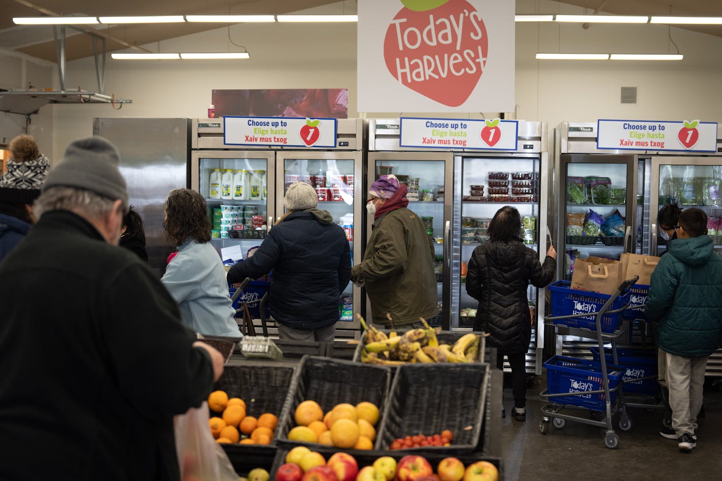 Open Cupboard customers selected fresh fruit, vegetables and fresh bread from stations at the food bank Friday, Feb. 24, 2023. The Oakdale program served 420 households a week before the pandemic. It now it serves 4,000 households.