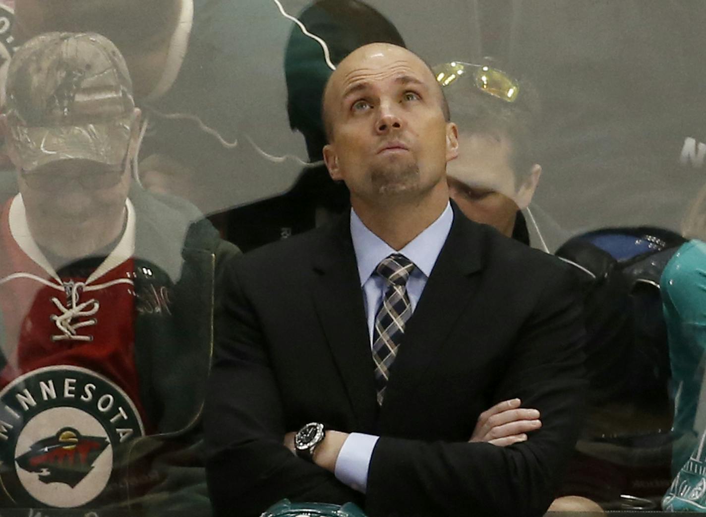 Minnesota Wild head coach Mike Yeo checks the scoreboard during the third period of an NHL hockey game against the Boston Bruins in St. Paul, Minn., Saturday, Feb. 13, 2016. The Bruins won 4-2. (AP Photo/Ann Heisenfelt)