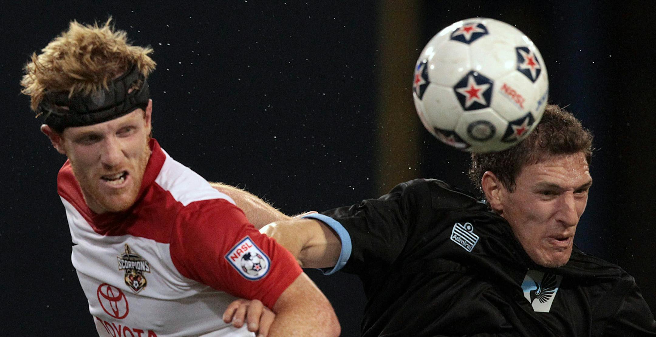 United FC’s Aaron Pitchkolan, right, battled for a ball in the home opener.