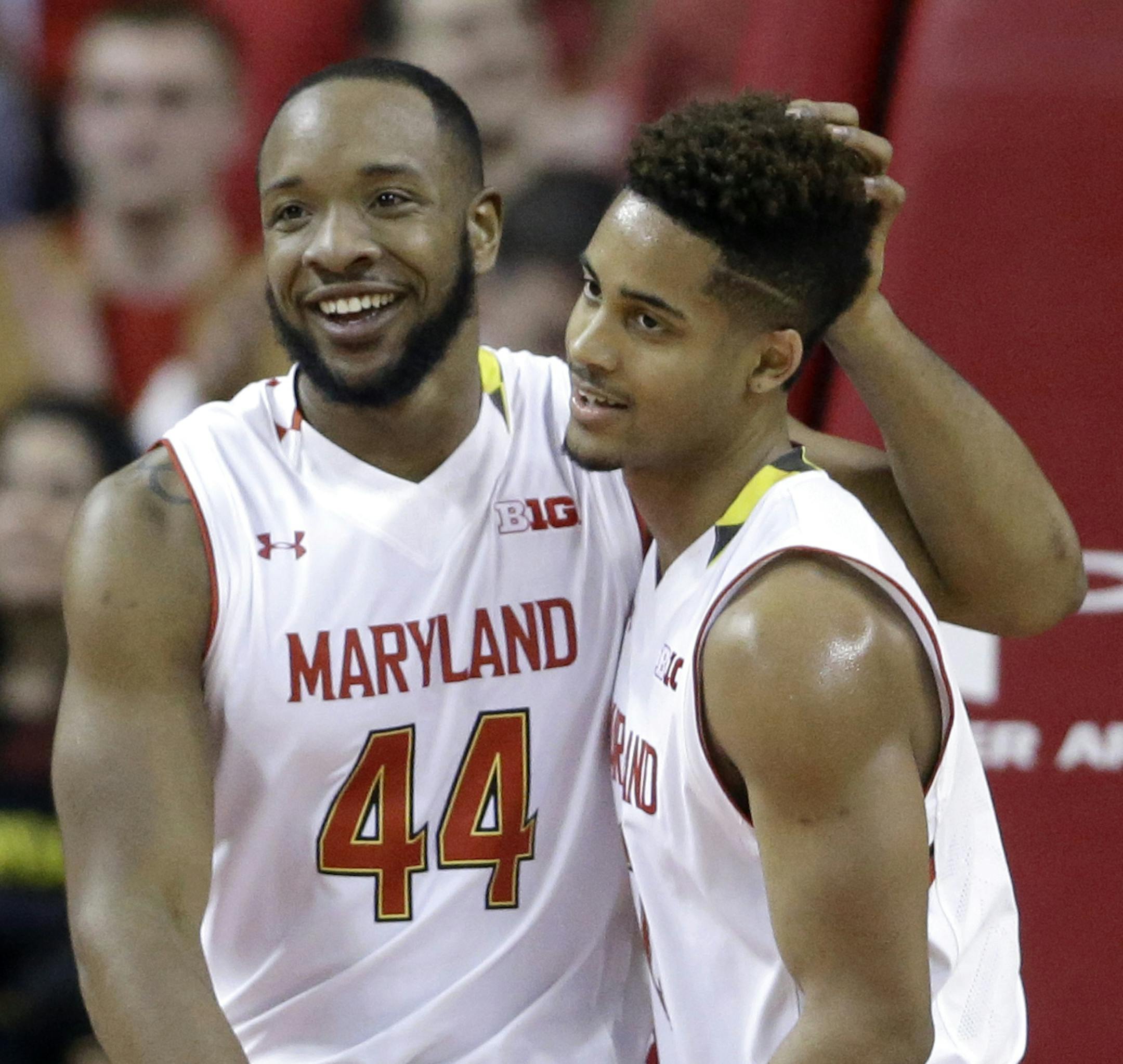 Maryland guard/forward Dez Wells, left, and guard Melo Trimble embrace as they walk off the court after Michigan State called a timeout in the first half of an NCAA college basketball game, Saturday, Jan. 17, 2015, in College Park, Md. (AP Photo/Patrick Semansky) ORG XMIT: OTK