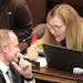 Democratic state Sen. Nicole Mitchell, right, from Woodbury, speaks with Sen. Robert D. Farnsworth, R-Hibbing, on the floor of the Senate on April 2 i