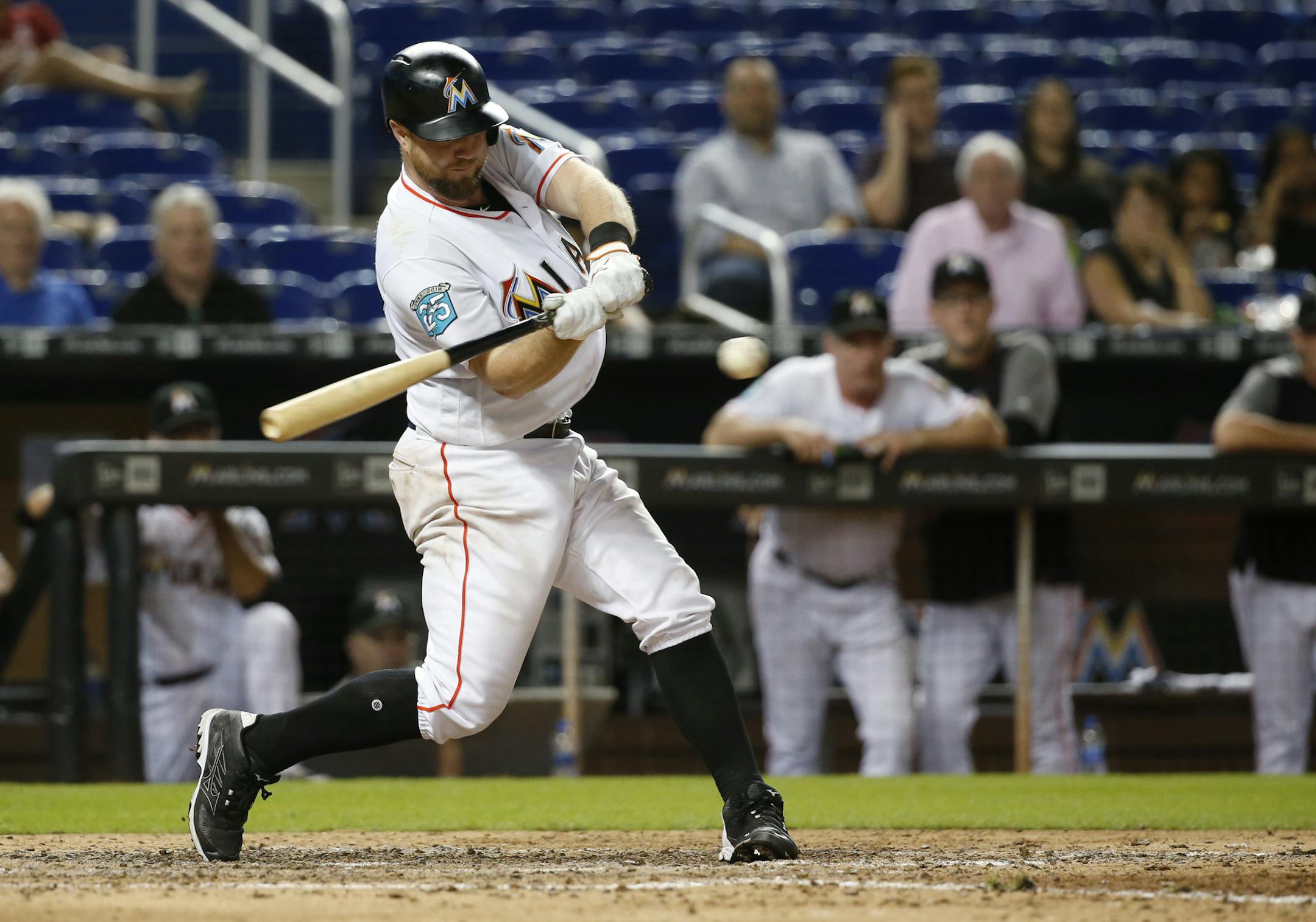Miami Marlins' Bryan Holaday hits a single that scored Miguel Rojas for the win during the 10th inning of a baseball game against the Milwaukee Brewers, Monday, July 9, 2018, in Miami. The Marlins defeated the Brewers 4-3 in 10 innings. (AP Photo/Wilfredo Lee)