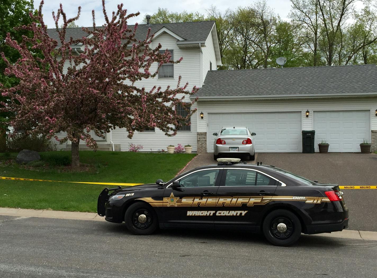 Law enforcement kept watch Sunday morning at the St. Michael home where two men were killed the night before.