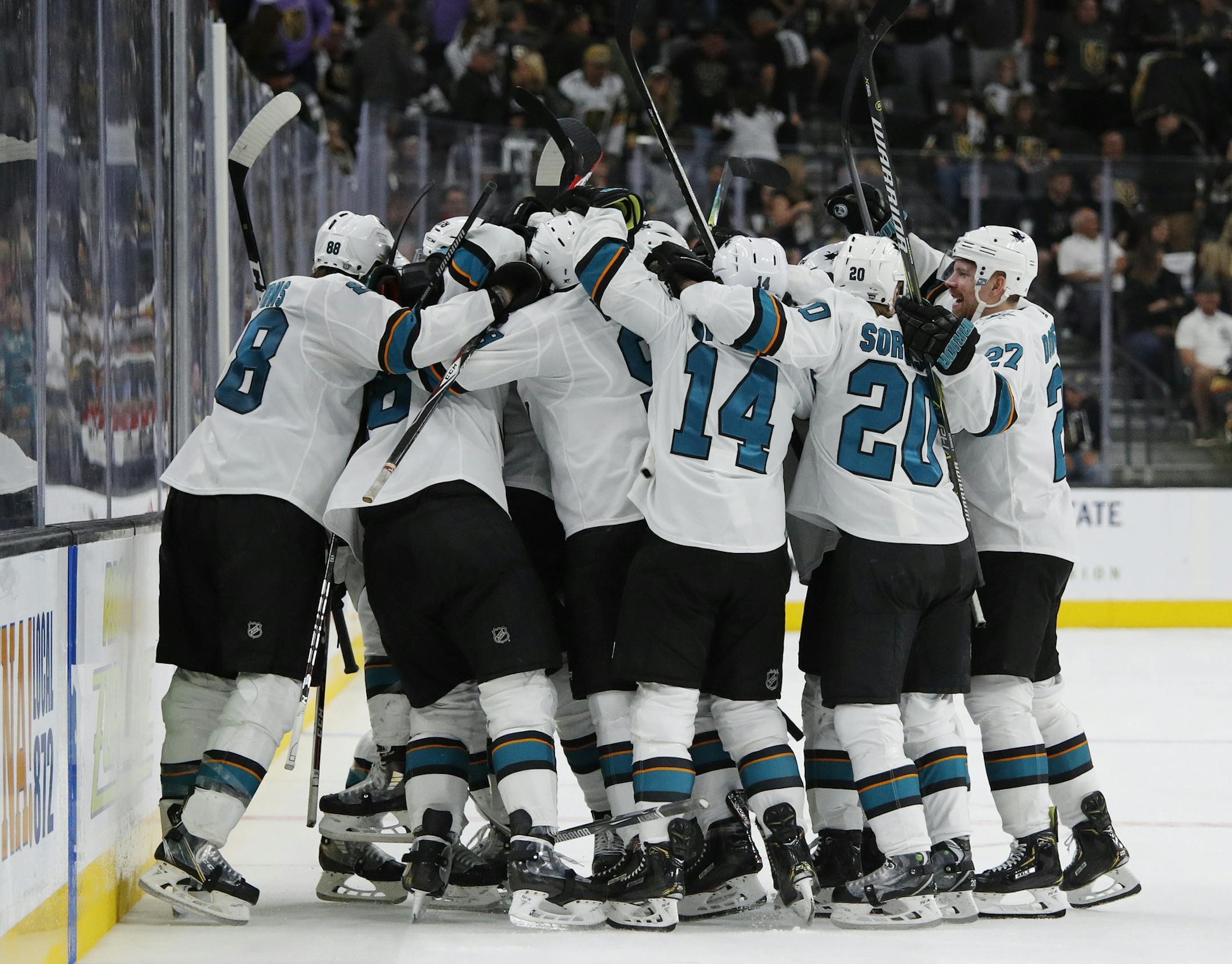 San Jose Sharks players celebrate after defeating the Vegas Golden Knights during the second overtime in Game 6 of a first-round NHL hockey playoff series Sunday, April 21, 2019, in Las Vegas. (AP Photo/John Locher)