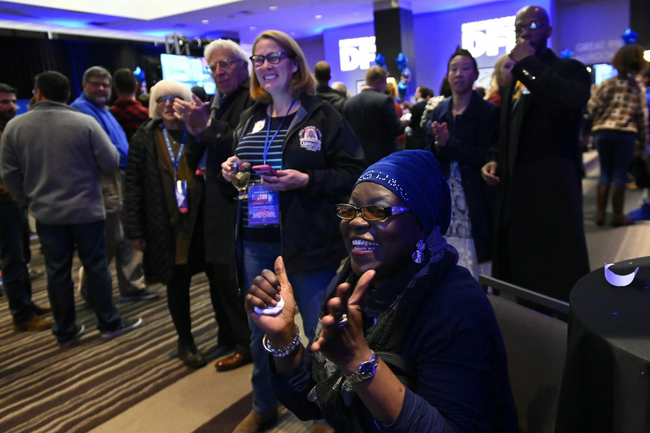 Muyibat Kazeem, of Brooklyn Center, celebrated after seeing election results favoring DFL congressional candidate Dean Phillips over incumbent Republican Erik Paulsen for the third district race cross the TV screen during Tuesday night's DFL headquarters election party in St. Paul.