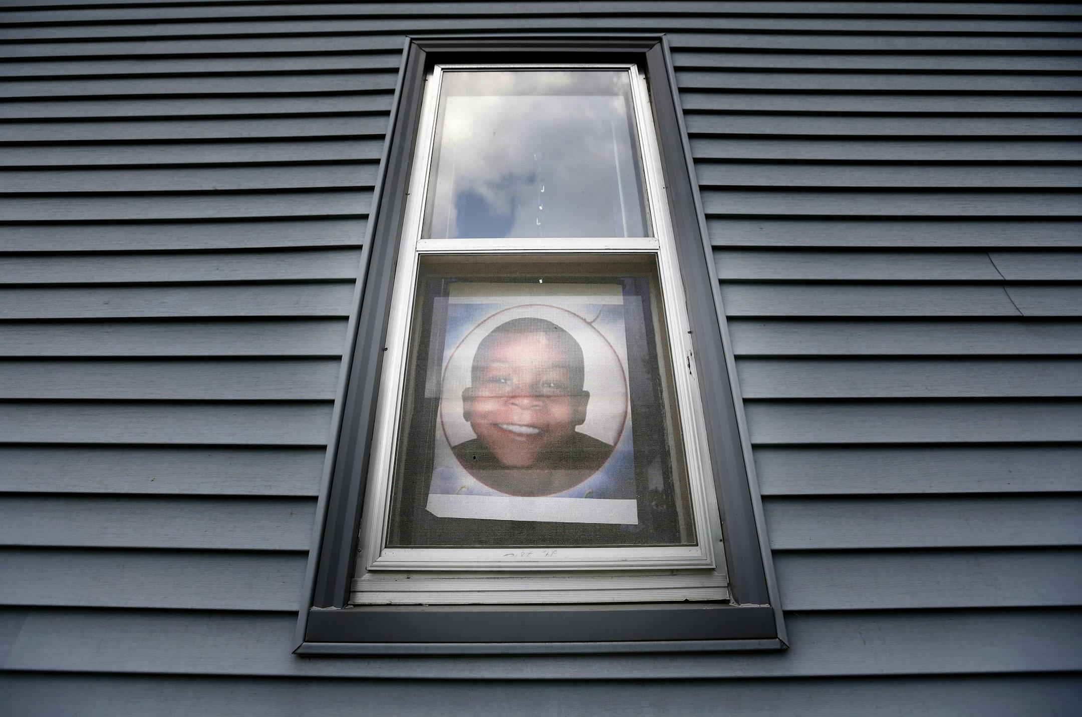An image of Terrell Mayes Jr. hangs in a window of the north Minneapolis home where he was killed by a stray bullet in 2011 while eating spaghetti.