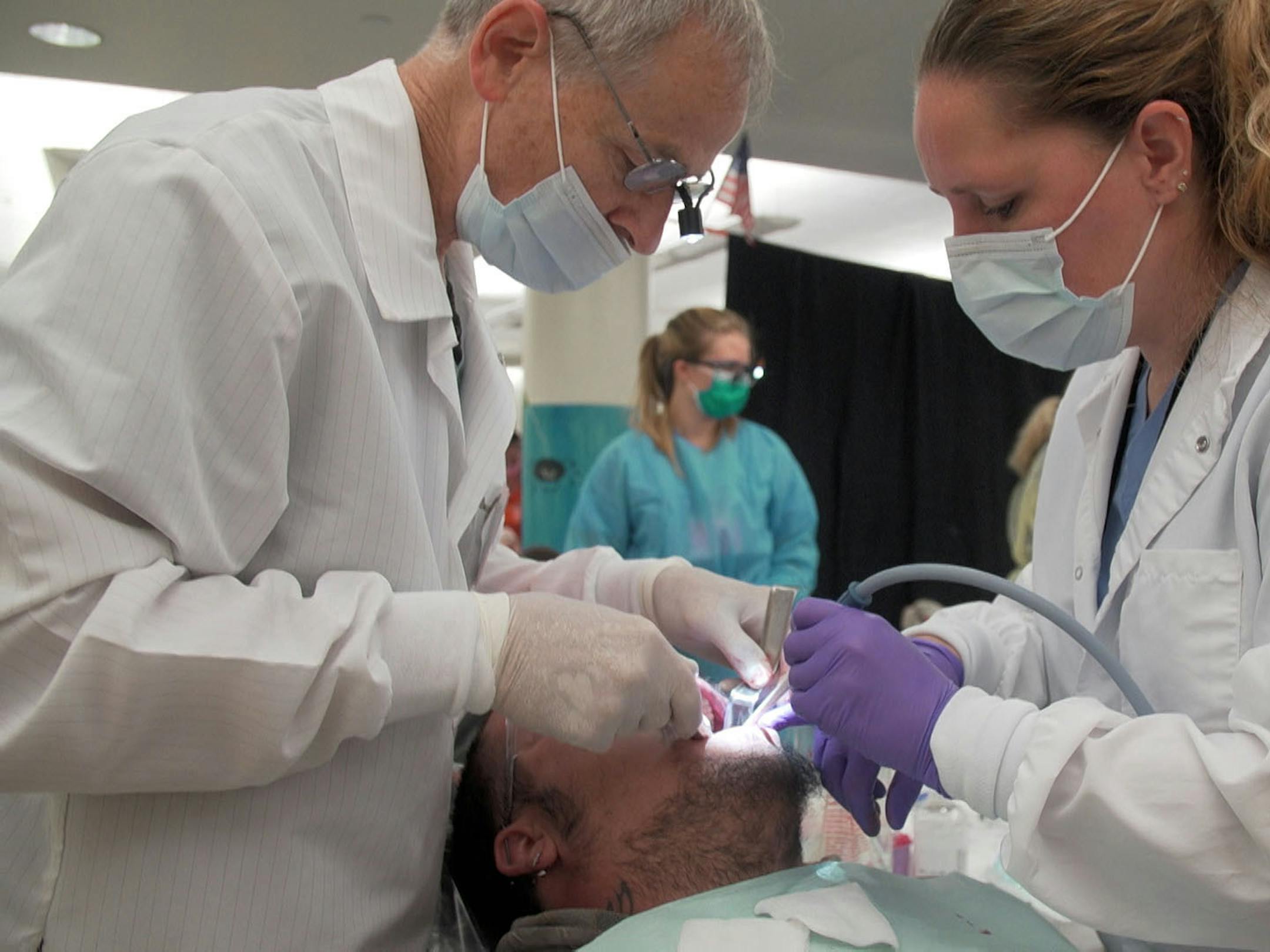 The lack of dental and vision coverage even for those with insurance means demand for Remote Area Medical's free mobile clinics has stayed strong. (PBS NewsHour/Kaiser Health News/TNS)