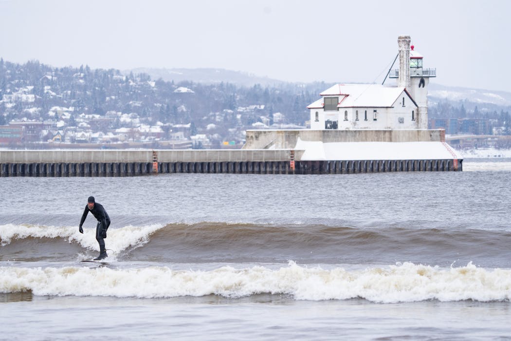 John Oldenborg surfed the waves of Lake Superior in Duluth on Jan. 11. Visit Duluth is trying to draw more year-round travel to the city. 