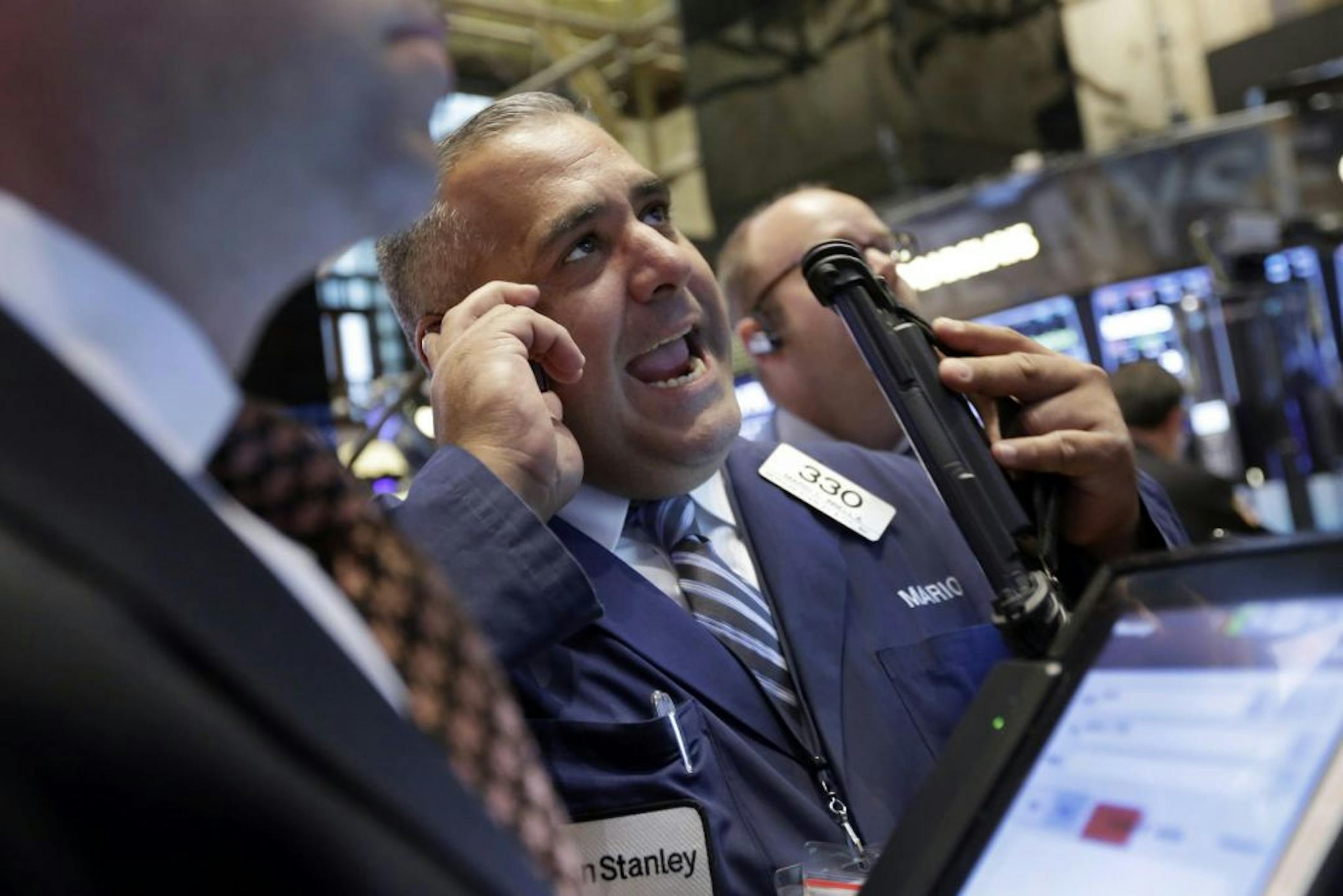 Trader Mario Innella works on the floor of the New York Stock Exchange, Monday, Aug. 24, 2015. U.S. stock markets plunged in early trading Monday following a big drop in Chinese stocks.