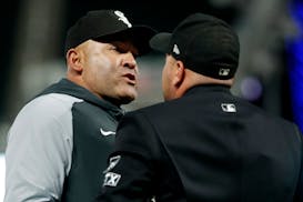 Chicago White Sox interim manager Miguel Cairo argues with home plate umpire Jansen Visconti, right, in the sixth inning of a baseball game with the M