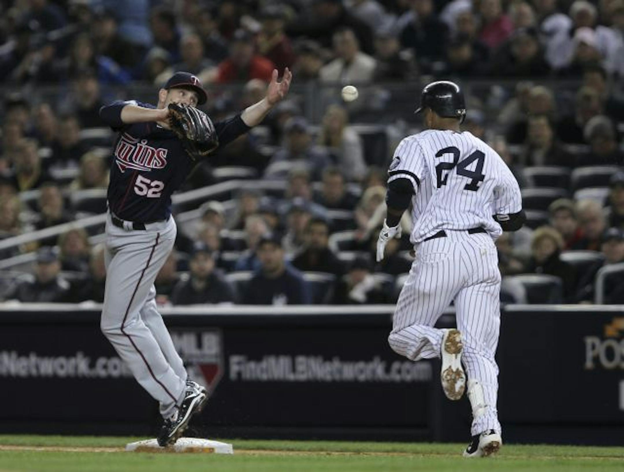Twins pitcher Brian Duensing (left) couldn't handle first baseman Michael Cuddyer's throw and Robinson Cano (right) had an infield single in the fourth Saturday. The ball went on to hit the Yankees' first base coach. New York went on to score three runs in the inning.
