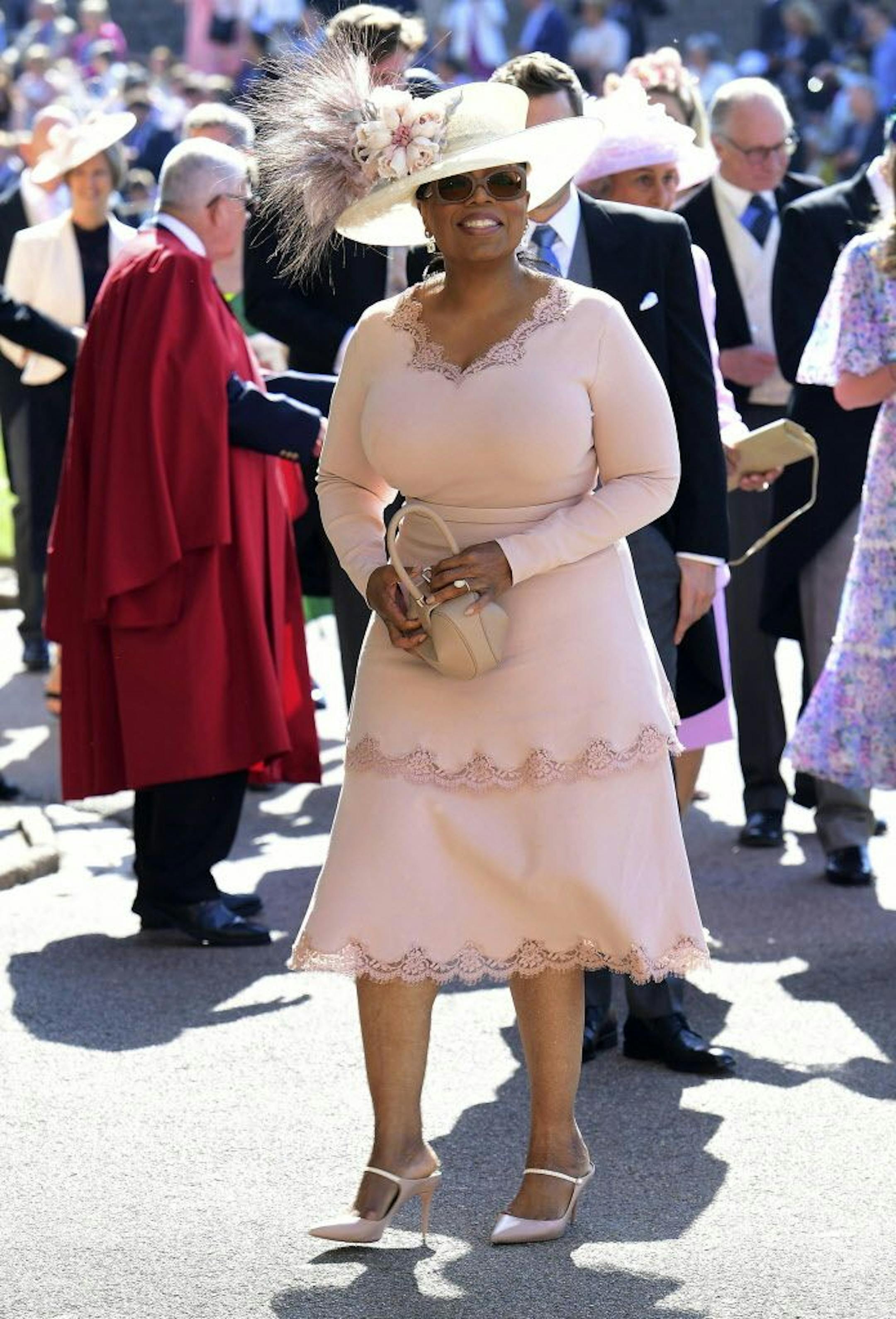 Oprah Winfrey smiles as she arrives at St George's Chapel at Windsor Castle the wedding ceremony of Prince Harry and Meghan Markle at St. George's Chapel in Windsor Castle in Windsor, near London, England, Saturday, May 19, 2018.