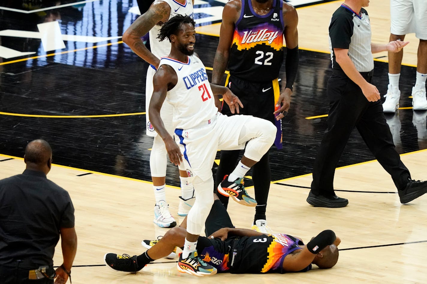 Los Angeles Clippers guard Patrick Beverley (21) smiles after fouling Phoenix Suns guard Chris Paul (3) during the second half of game 5 of the NBA basketball Western Conference Finals, Monday, June 28, 2021, in Phoenix. Beverley was called for a flagrant foul on the play. (AP Photo/Matt York)