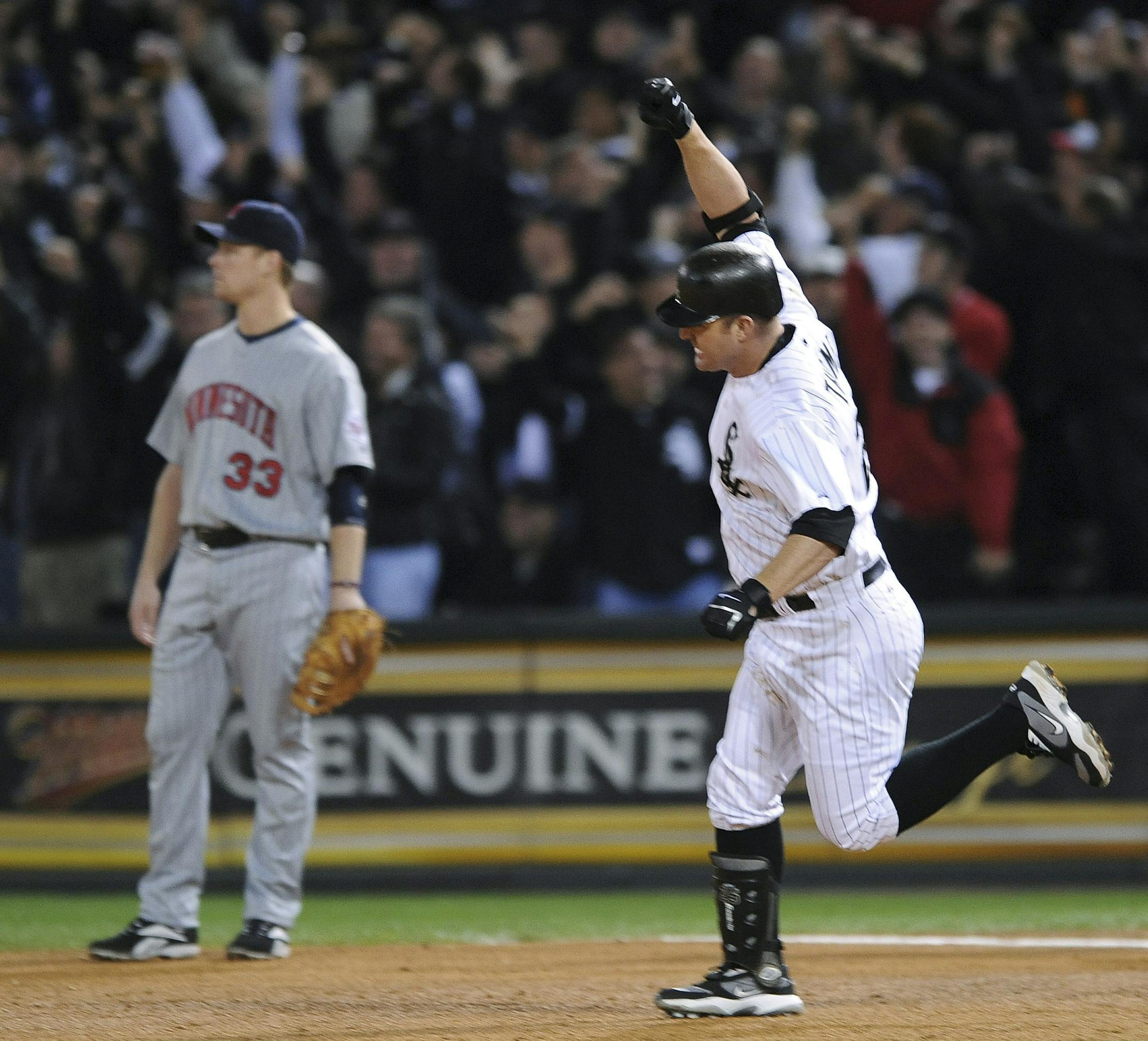 Chicago White Sox's Jim Thome celebrates in front of Minnesota Twins first baseman Justin Morneau (33) after hitting a home run during the seventh inning of the American League Central Division tiebreaker baseball game Tuesday, Sept. 30, 2008, in Chicago. The White Sox won 1-0, and will play the Tampa Bay Rays in the first round of the playoffs. (AP Photo/Paul Beaty) ORG XMIT: ILMG117