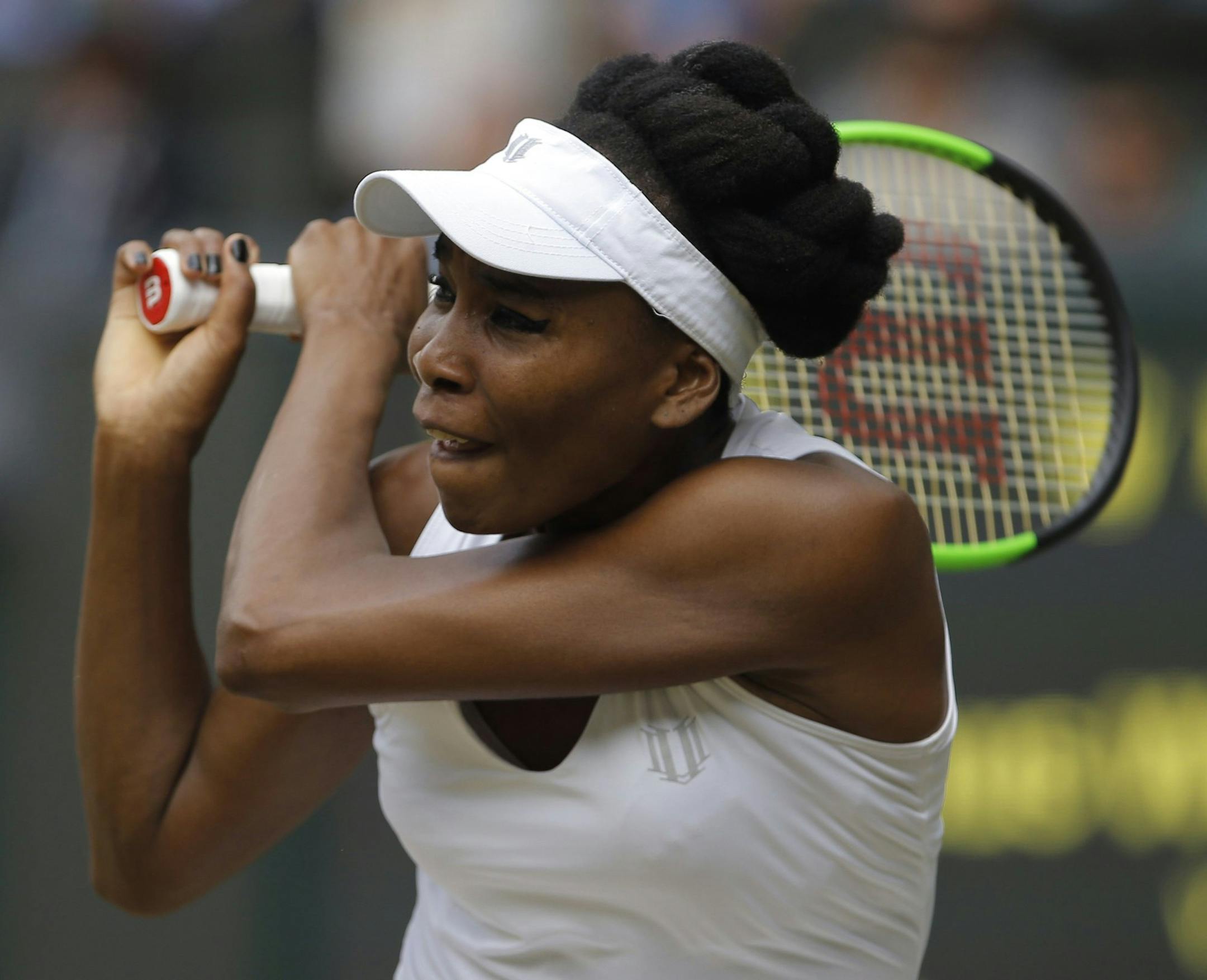 Venus Williams of the United States returns to Britain's Johanna Konta during their Women's Singles semifinal match on day nine at the Wimbledon Tennis Championships in London Thursday July 13, 2017. (Andrew Couldridge/Pool Photo via AP)